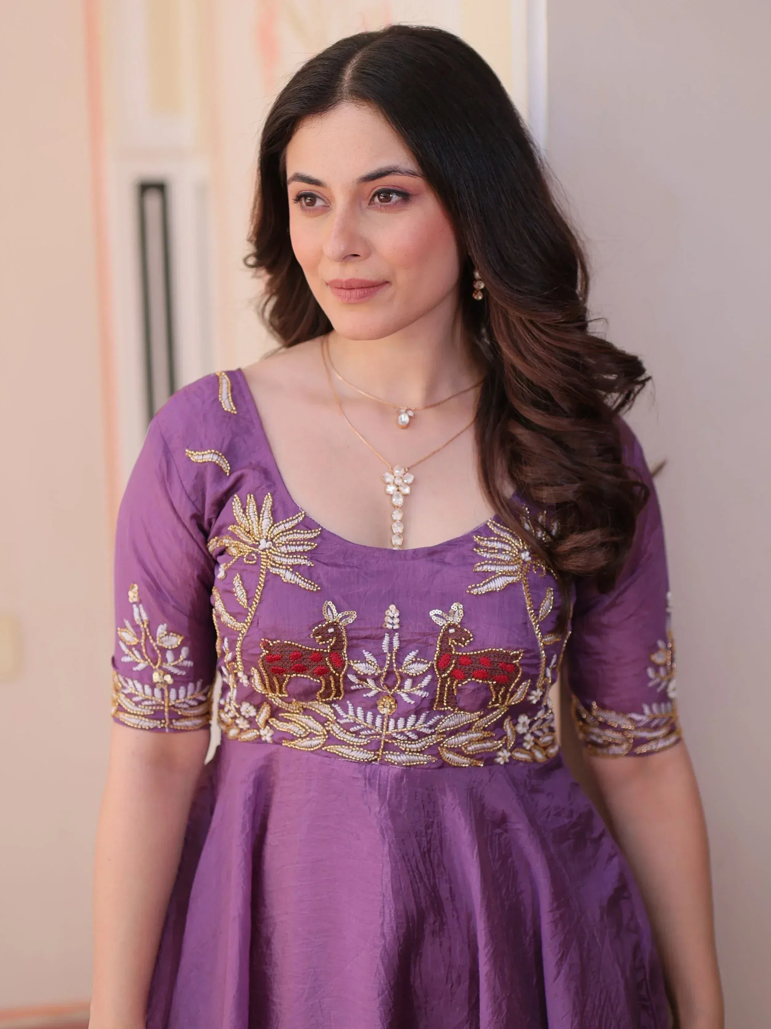Purple ethnic gown with deer and floral embroidery, perfect for Indian occasions
