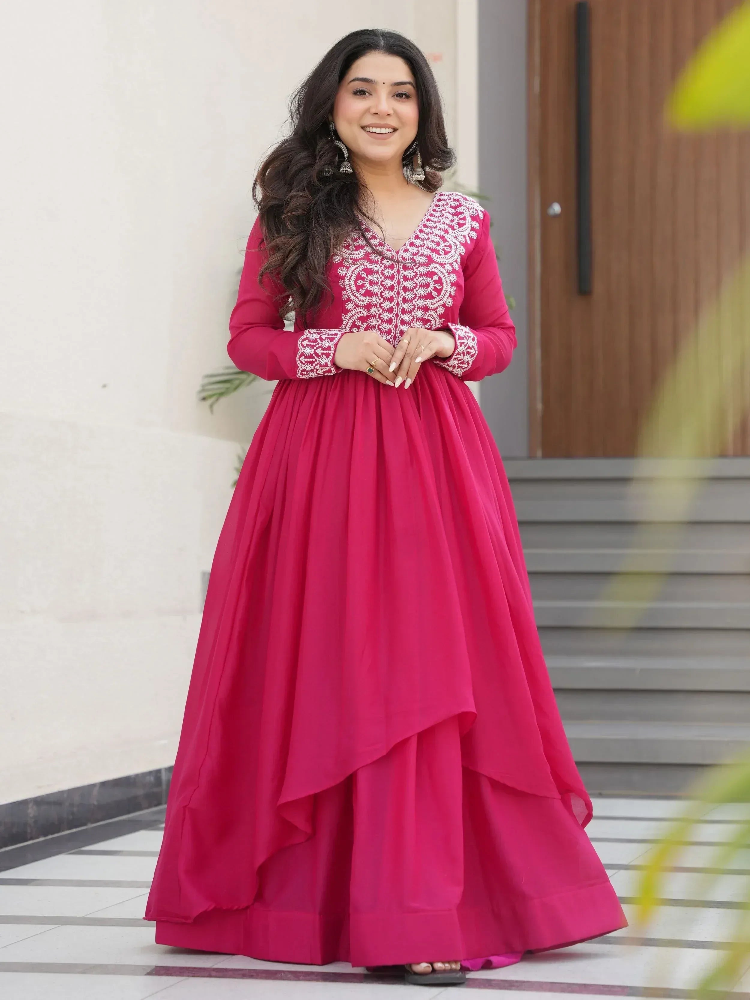 Pink ethnic gown with white embroidery, long sleeves, and layered skirt for women