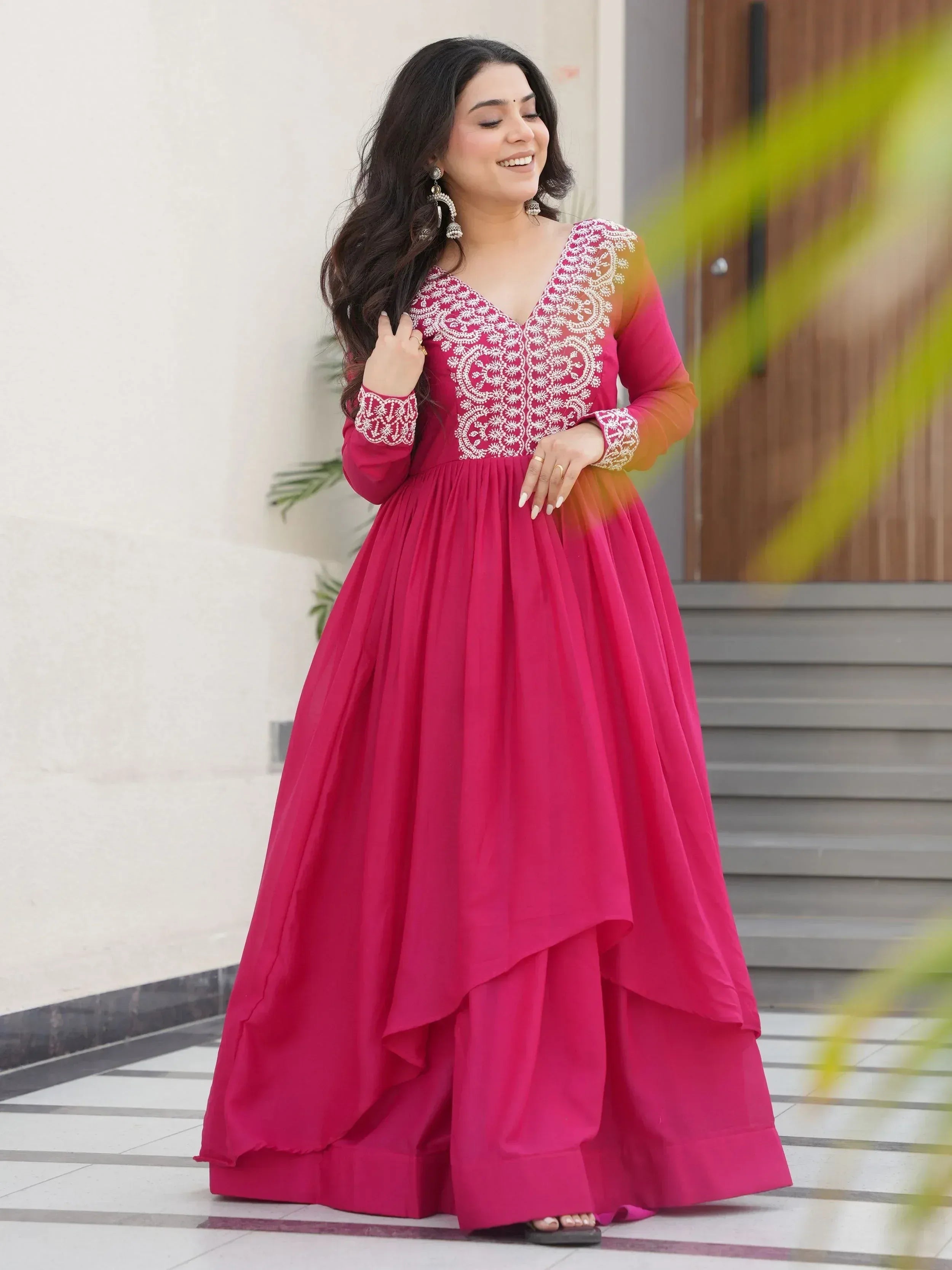 Pink ethnic gown with white embroidery, long sleeves, and layered skirt for women