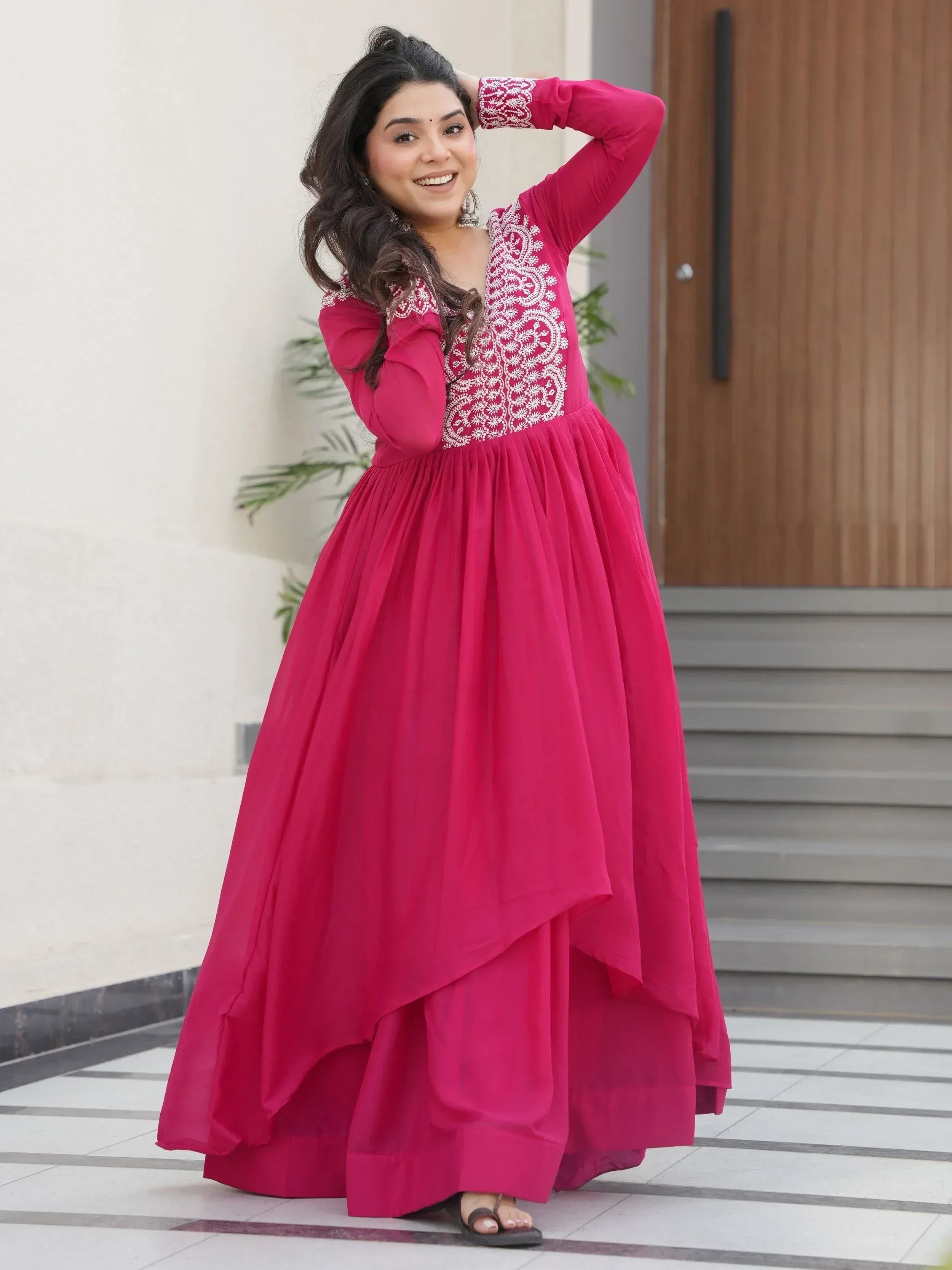 Pink ethnic gown with white embroidery, long sleeves, and flared skirt for women