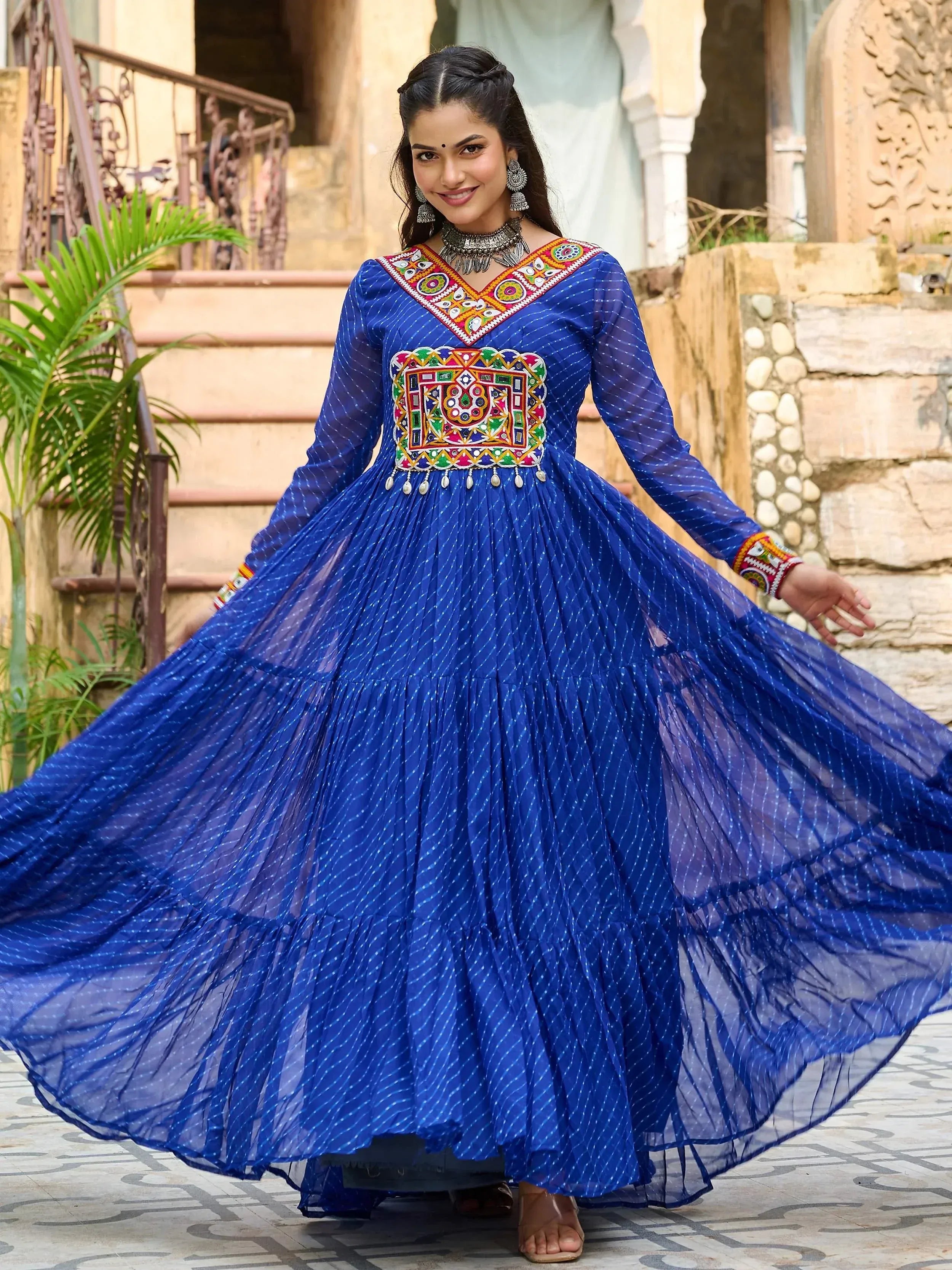 Blue ethnic gown with colorful mirror work, perfect for Indian occasions and festive wear.