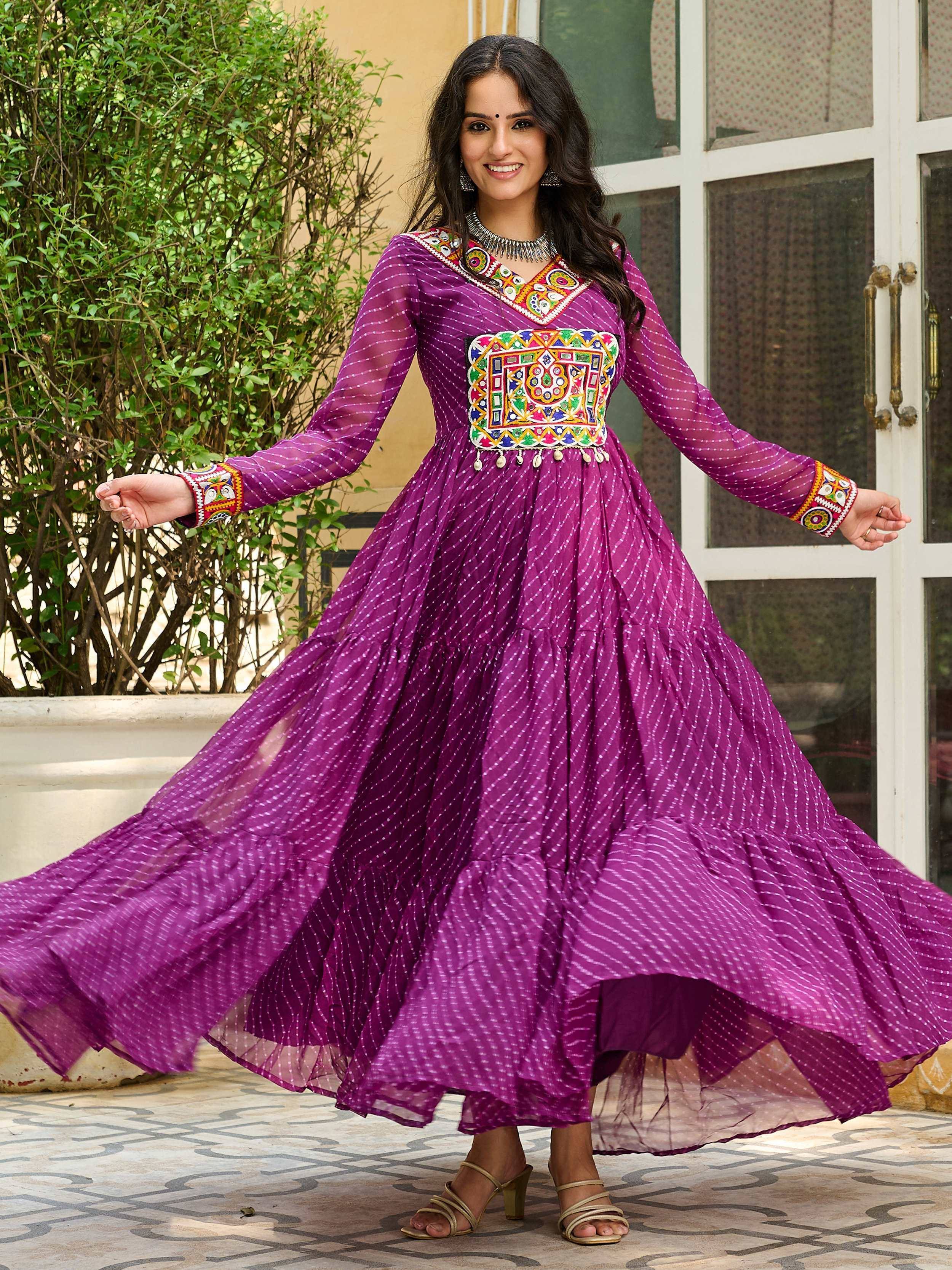 Purple ethnic gown with colorful mirror work and sheer sleeves, perfect for festive occasions
