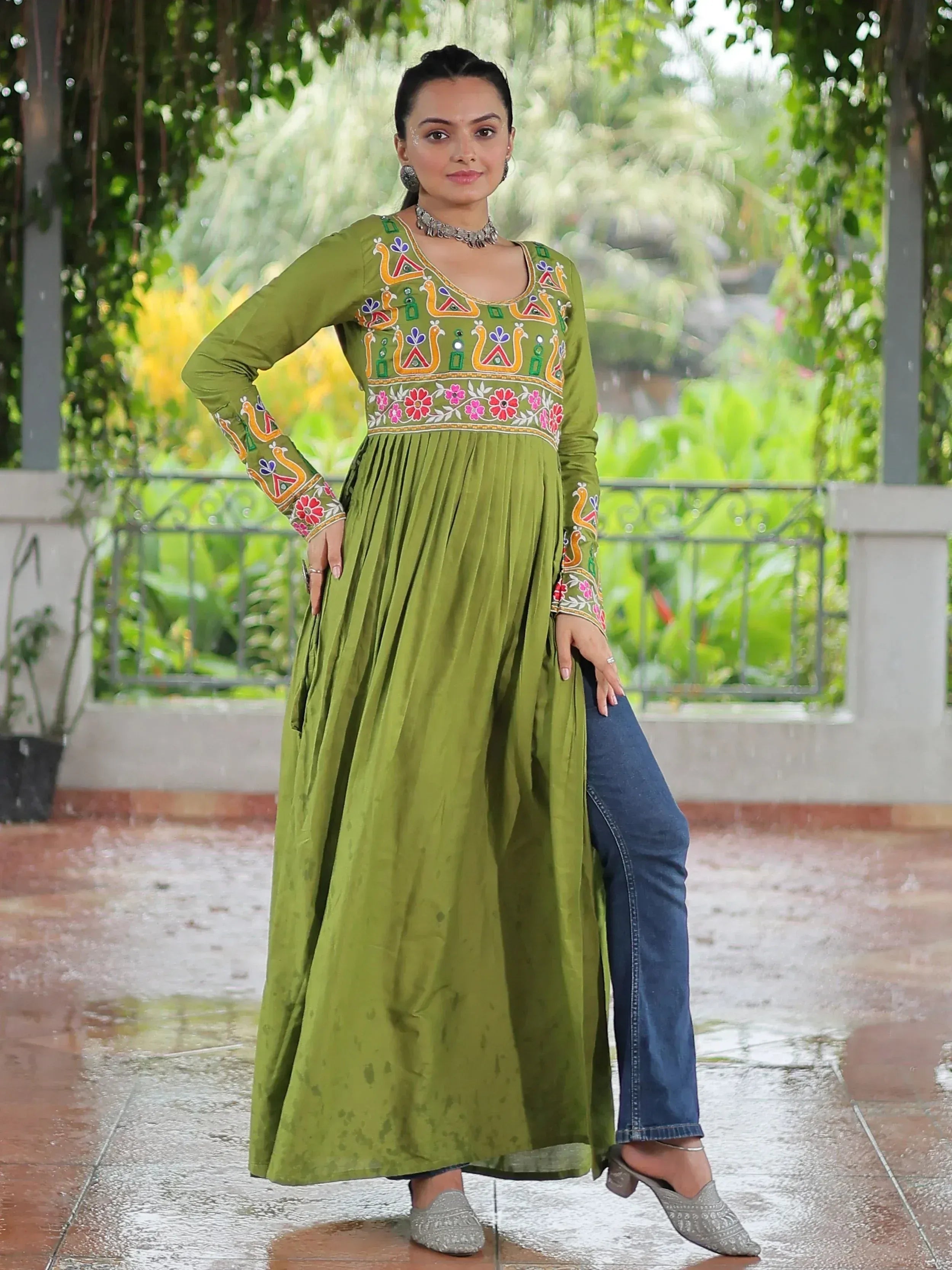 Olive green embroidered ethnic kurta with floral and peacock motifs, paired with jeans for a fusion look