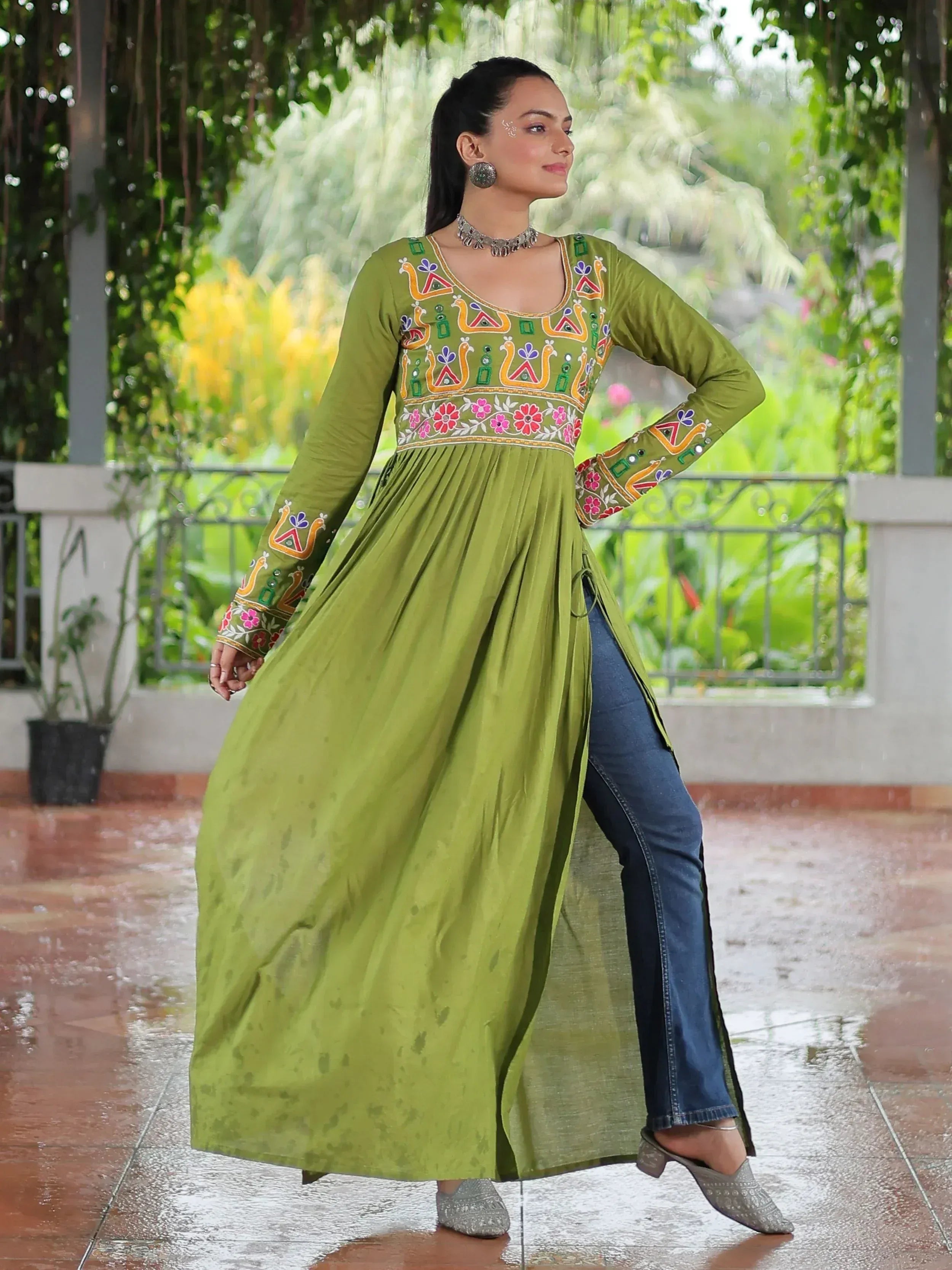 Green embroidered ethnic kurti with side slit, paired with jeans, for women's Indian wear