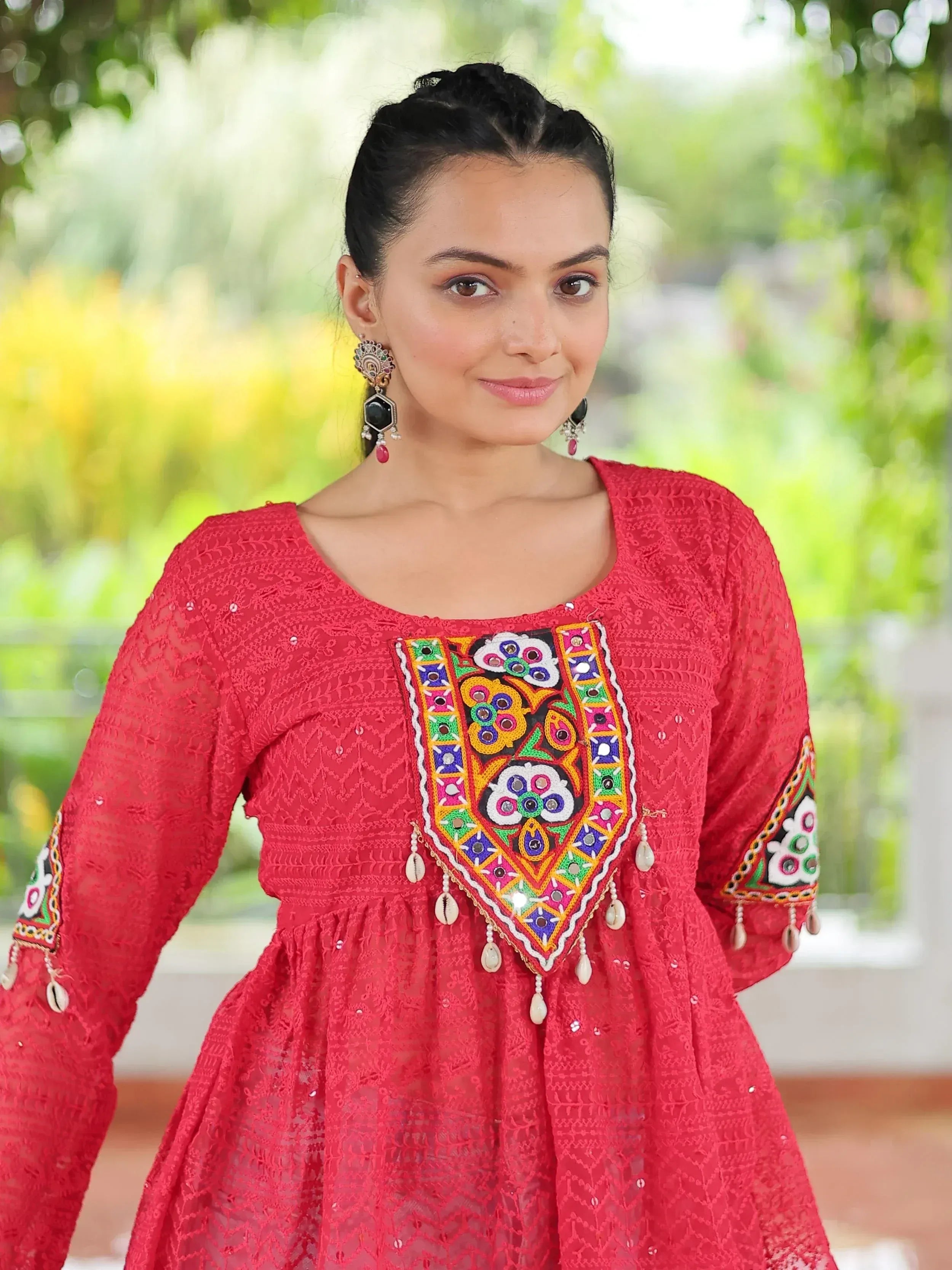 Red embroidered ethnic kurti with colorful mirror work and shell tassels