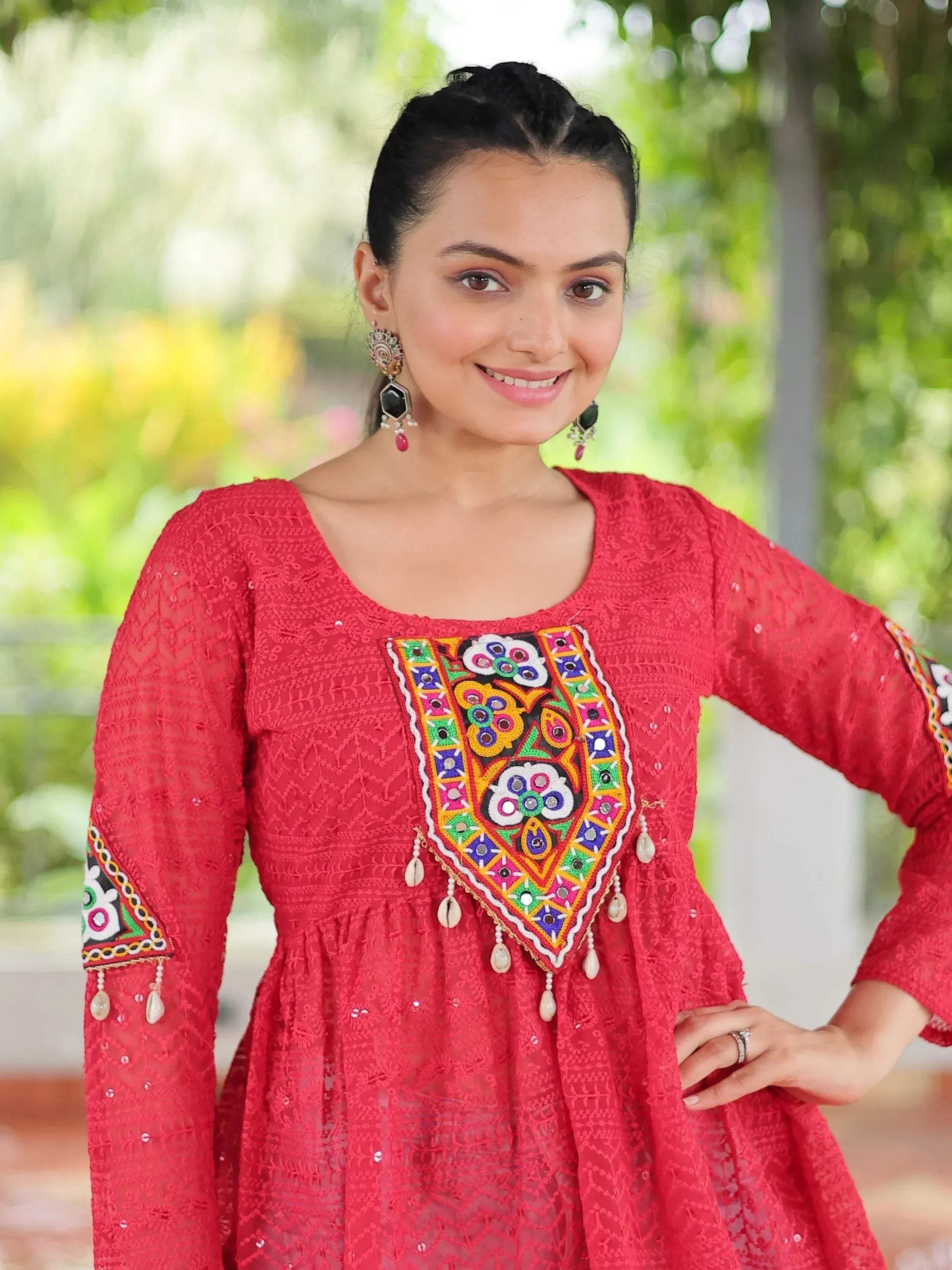 Red ethnic kurti with colorful mirror work and lace detailing, perfect for festive occasions