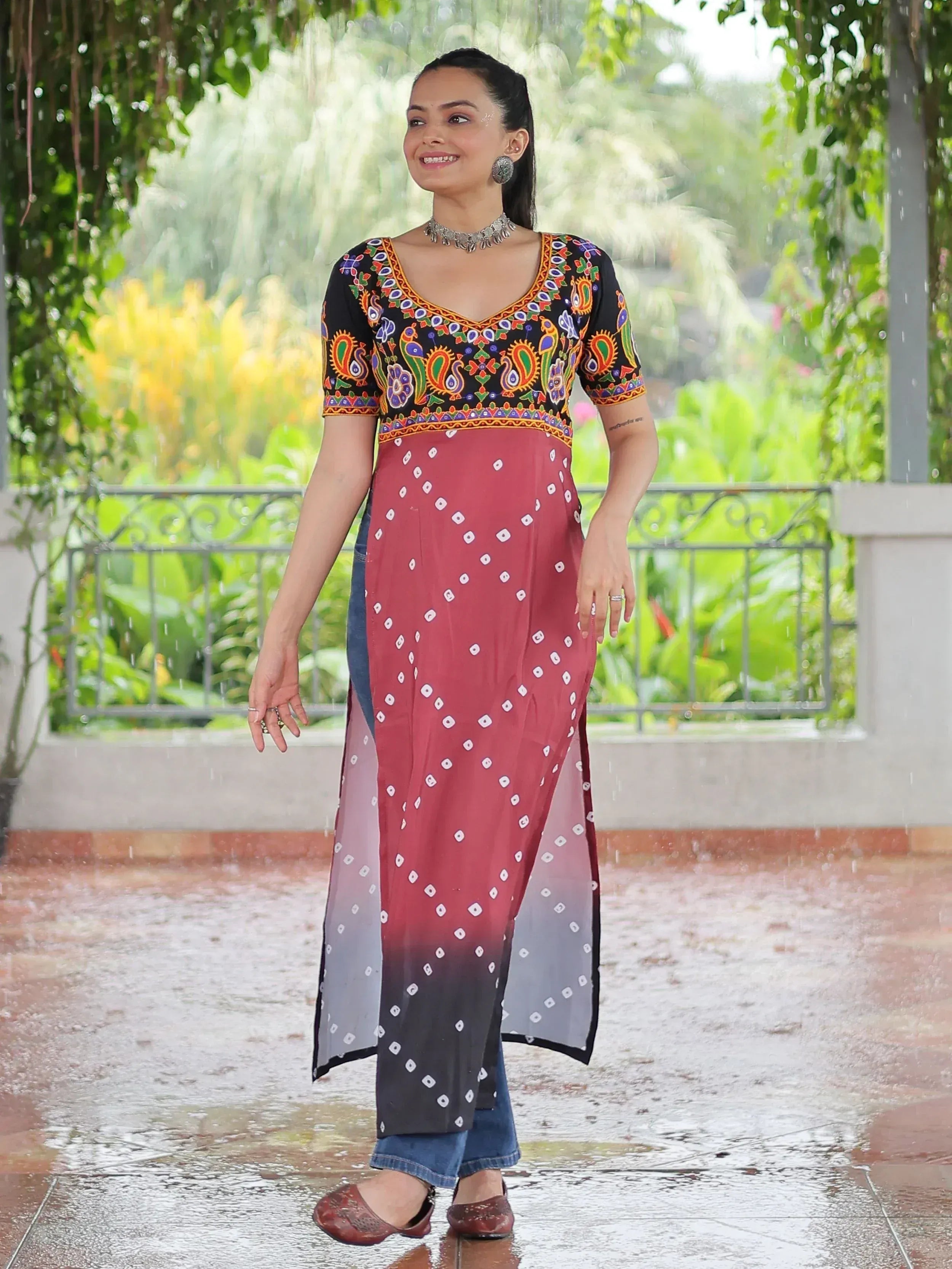 Woman in colorful embroidered kurta with ombre dupatta, styled with jeans for ethnic fusion look