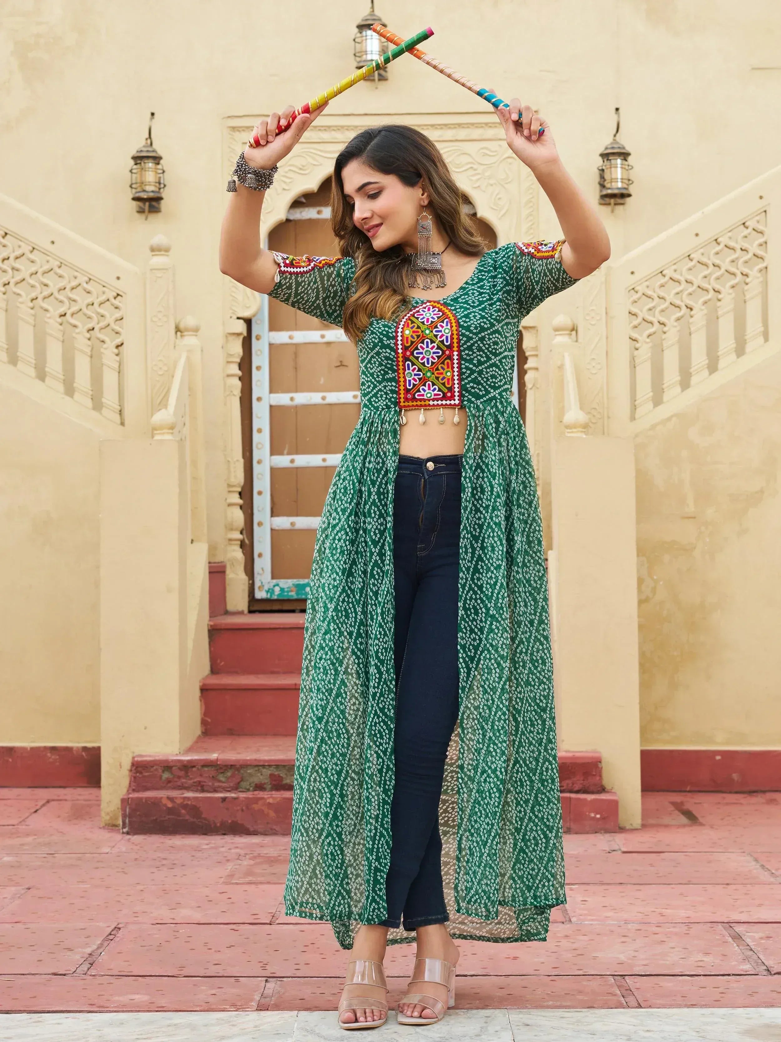 Green printed ethnic kurti with mirror work, paired with jeans, perfect for festive occasions and Indian wear.