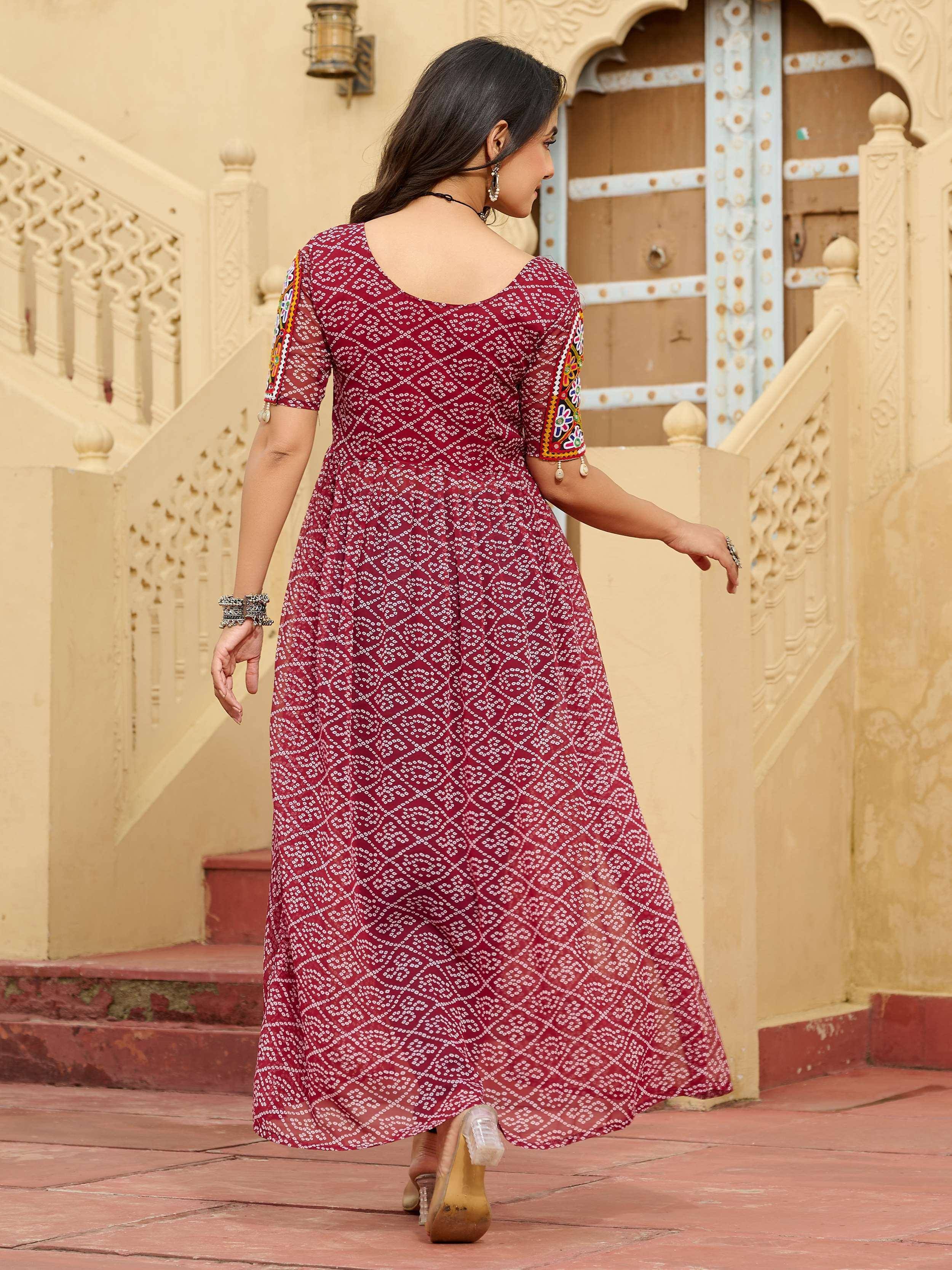 Maroon ethnic gown with white print and embroidered sleeves, perfect for Indian occasions