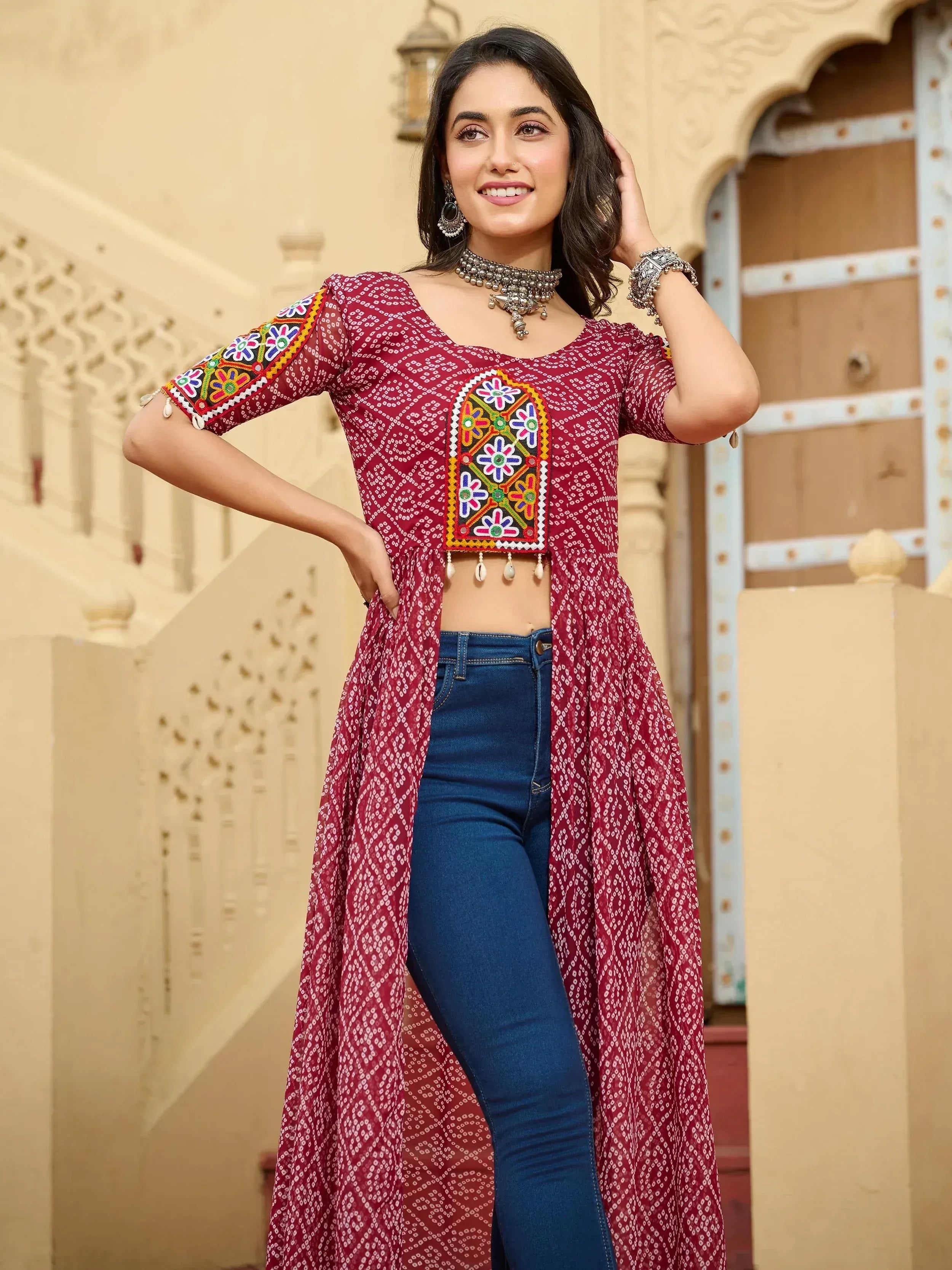 Maroon embroidered ethnic kurta with mirror work, paired with jeans, perfect for Indian festive wear