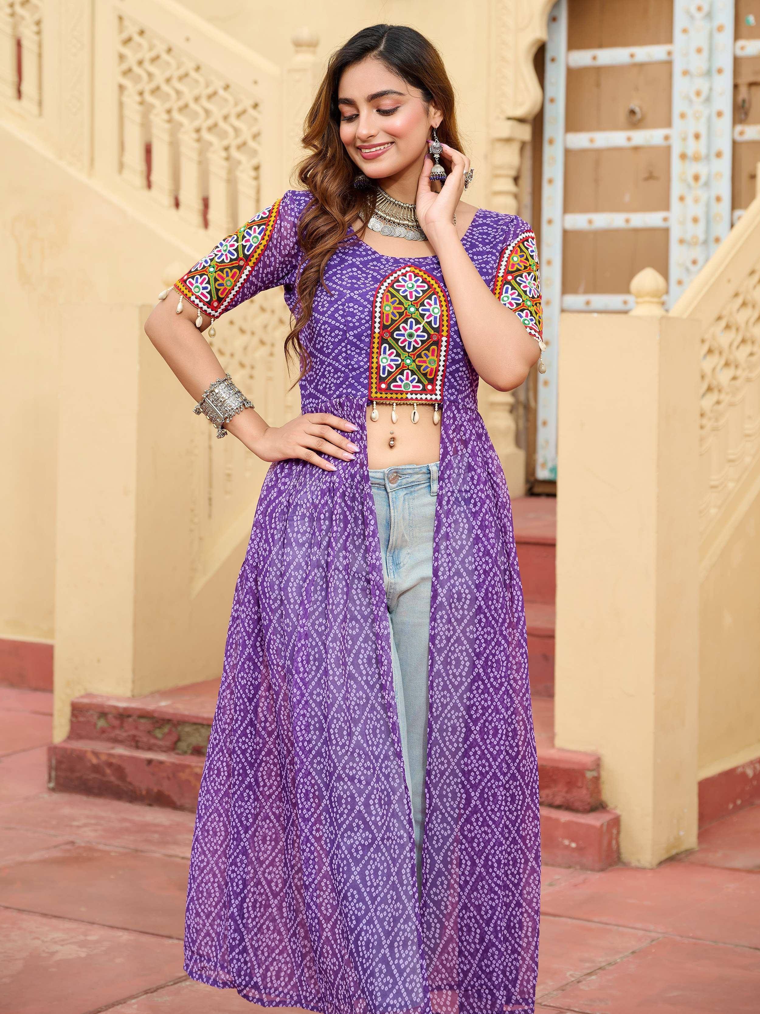 Purple embroidered ethnic kurti with mirror work, paired with jeans, perfect for Indian festive wear