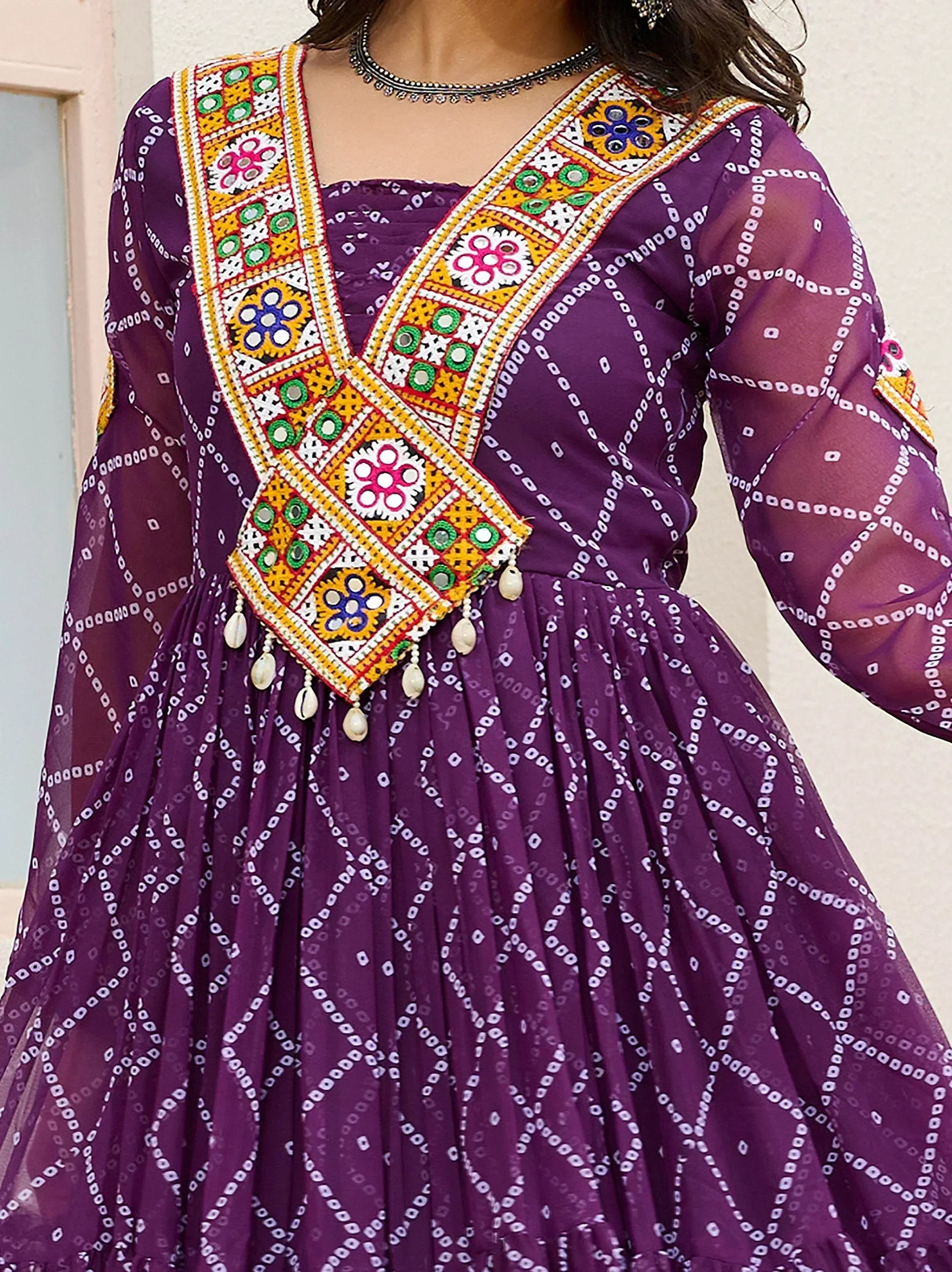 Purple ethnic gown with mirror work and bandhani print, perfect for Indian festive occasions