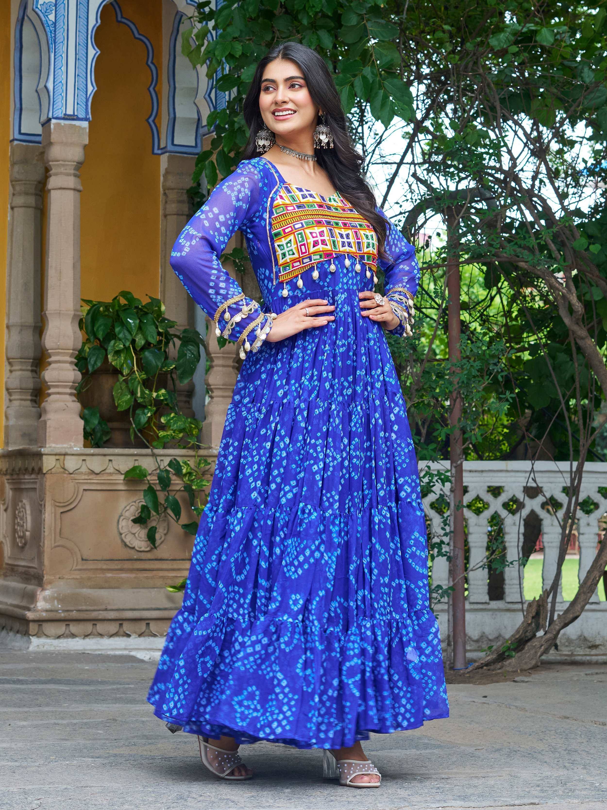 Woman in vibrant blue ethnic gown with colorful embroidery, perfect for Indian festive occasions