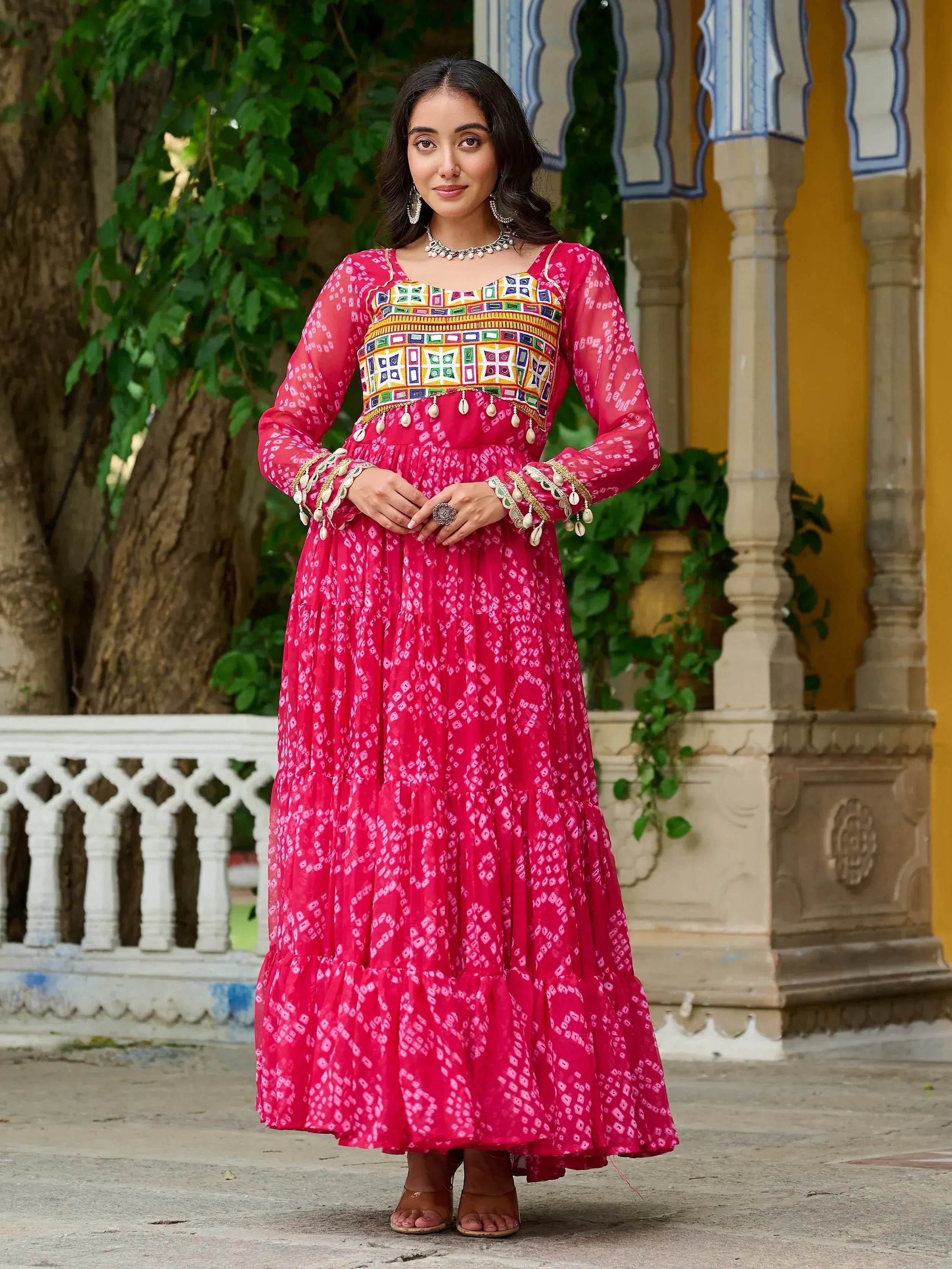 Pink ethnic gown with mirror work and bandhani print, perfect for Indian festive occasions