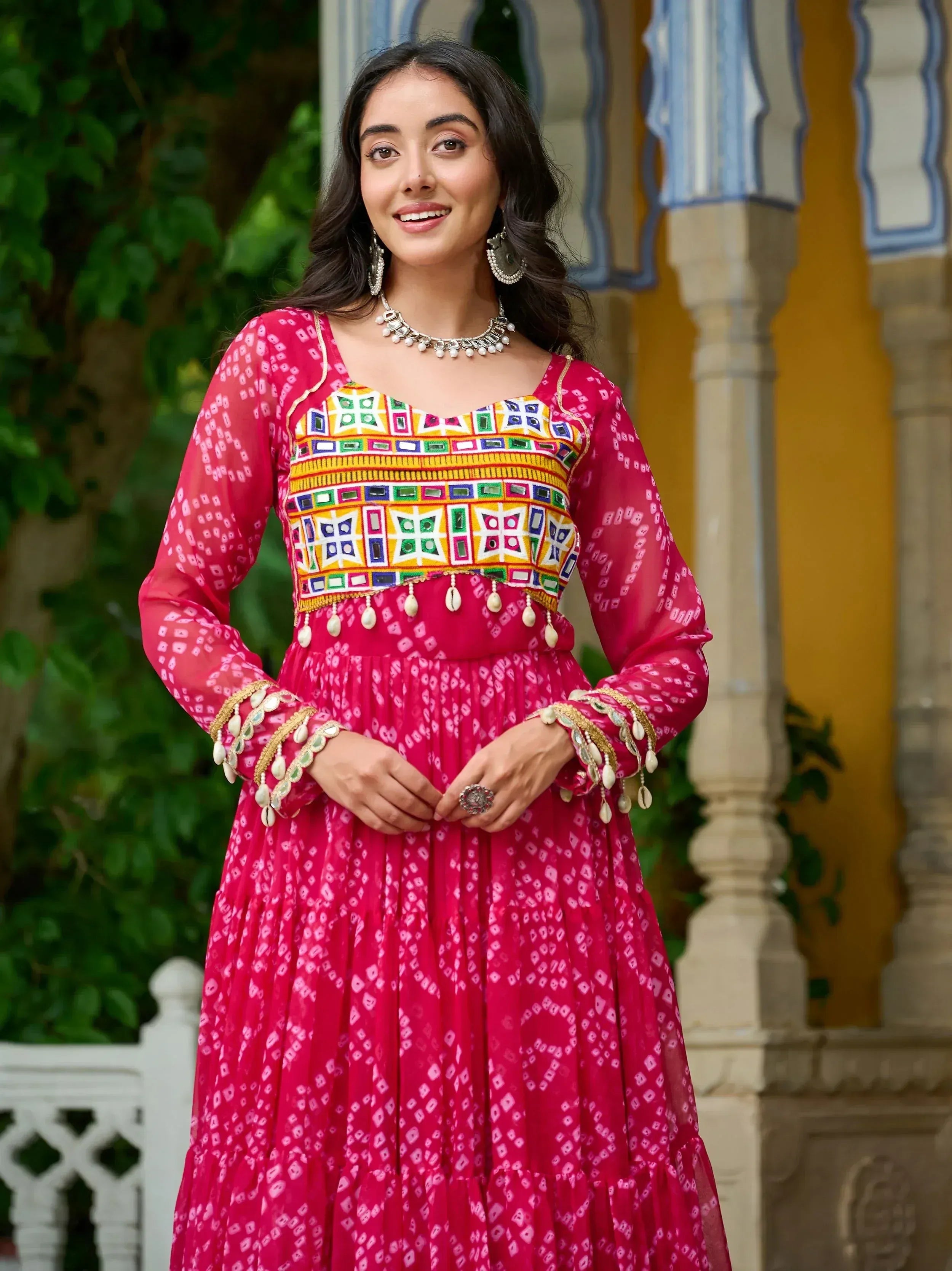 Pink ethnic gown with mirror work and bandhani print, perfect for Indian festive occasions