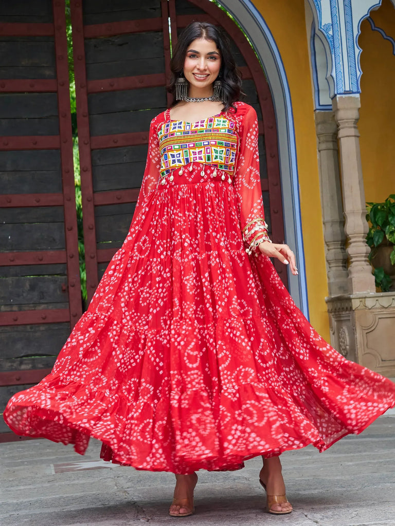 Red ethnic gown with colorful embroidery and tiered skirt, perfect for Indian festive wear