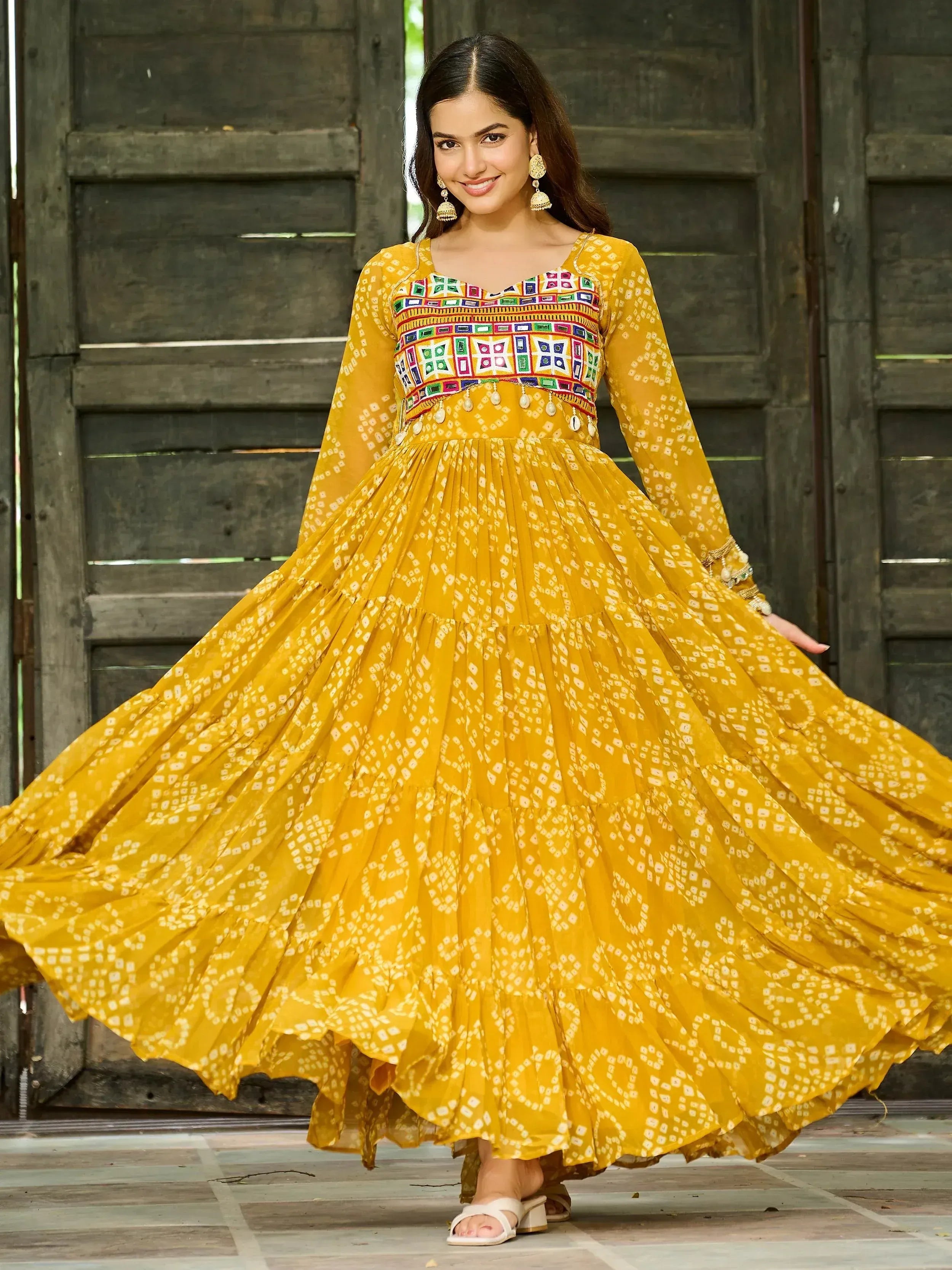 Yellow printed ethnic gown with colorful embroidery, perfect for Indian festive occasions