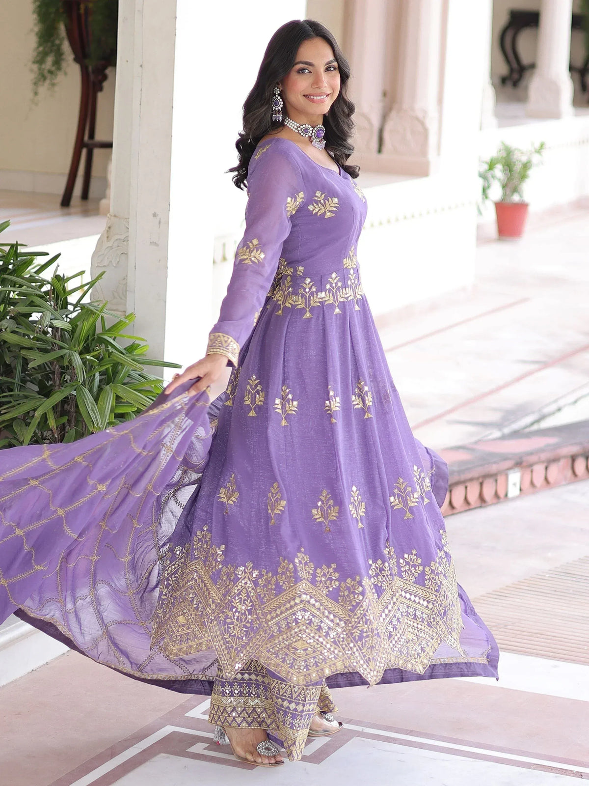 Purple ethnic gown with gold embroidery, perfect for Indian occasions and festive wear.