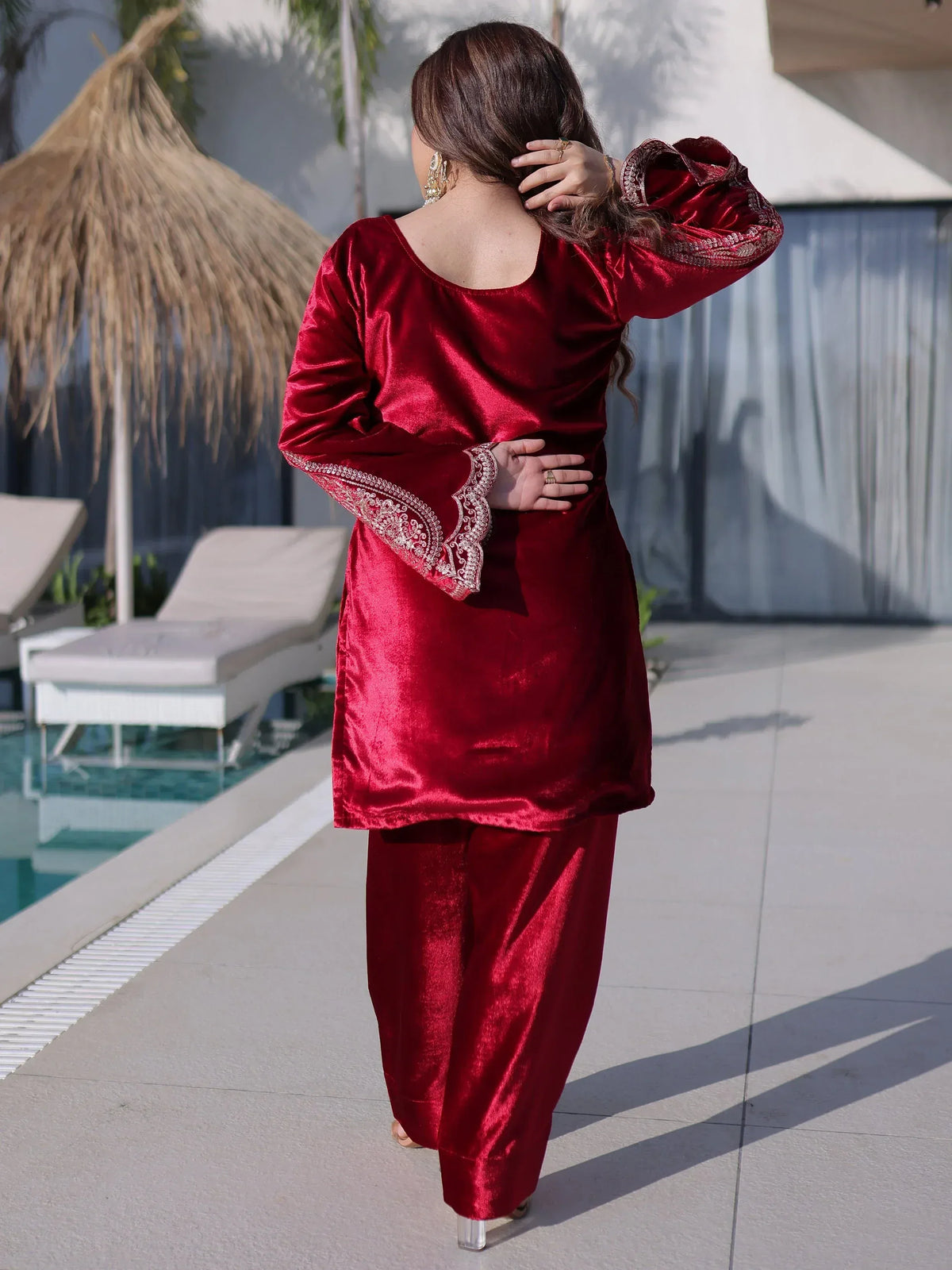Red velvet salwar kameez with embroidered sleeves, perfect for Indian ethnic wear occasions