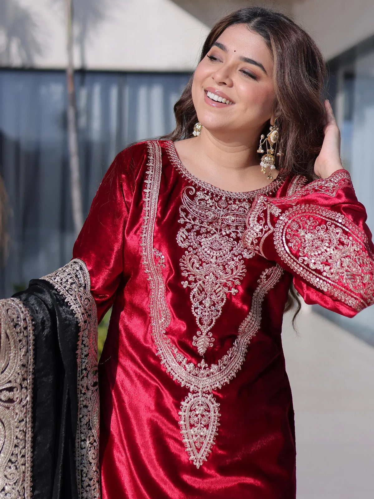 Red velvet ethnic kurti with gold embroidery, paired with black dupatta for festive occasions