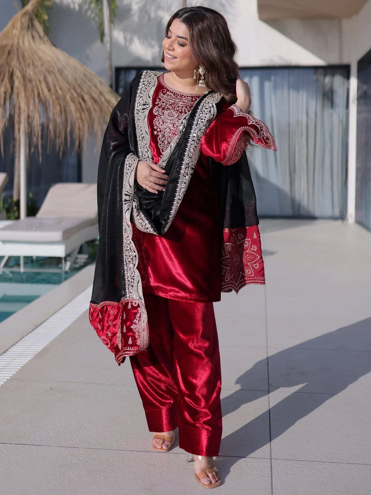 Red velvet ethnic suit with black embroidered dupatta, perfect for festive occasions and parties.