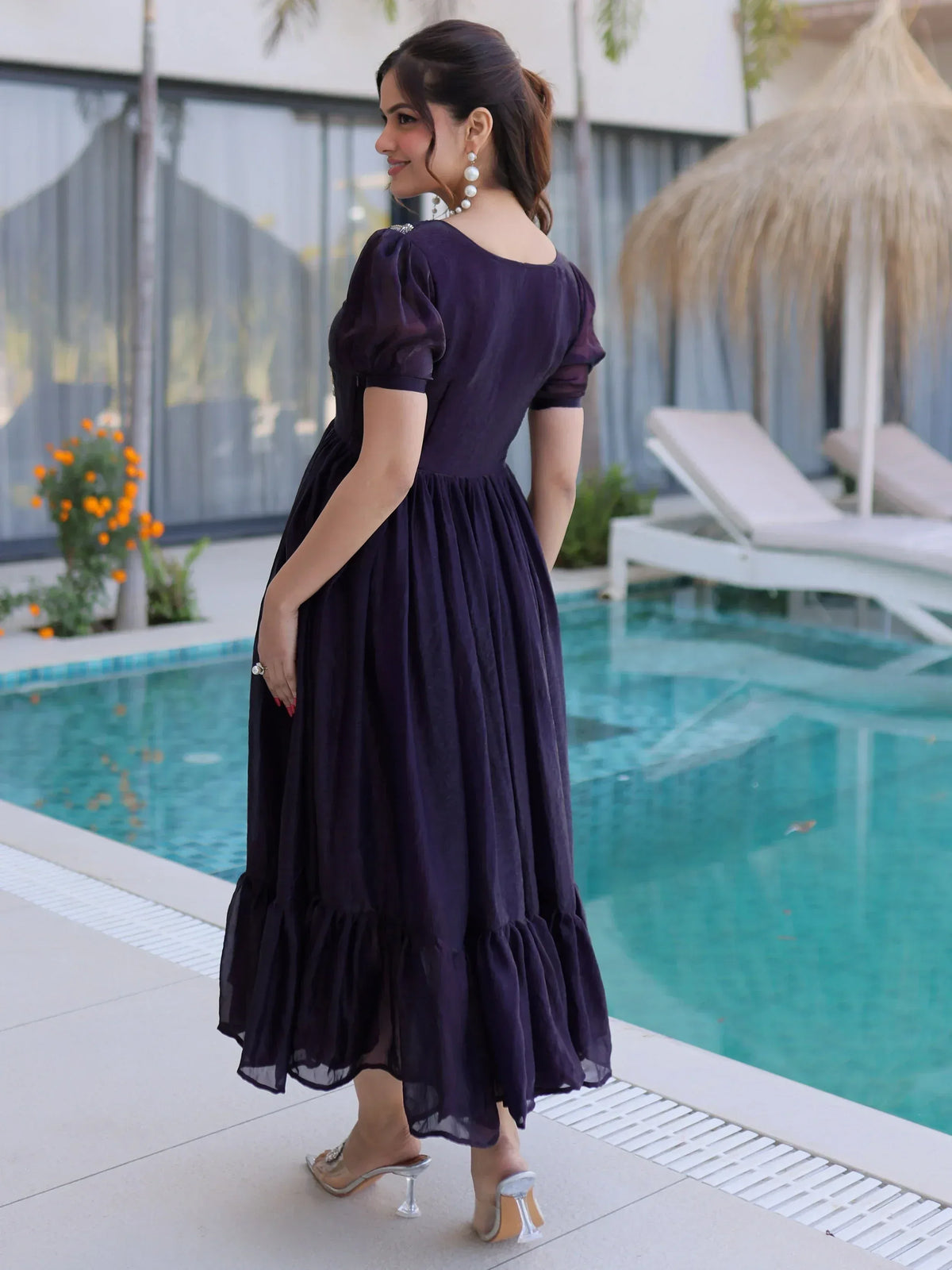 Purple ethnic gown with puff sleeves and ruffle hem, perfect for poolside events