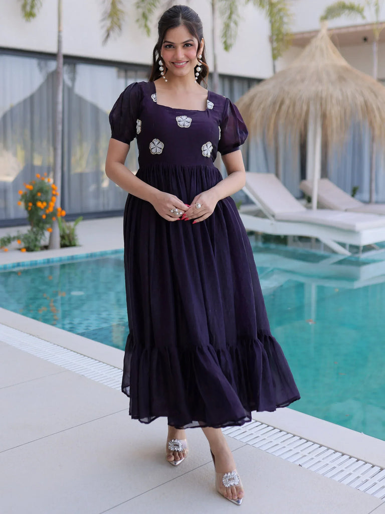 Elegant purple ethnic gown with floral embroidery, perfect for parties or weddings, styled by poolside.