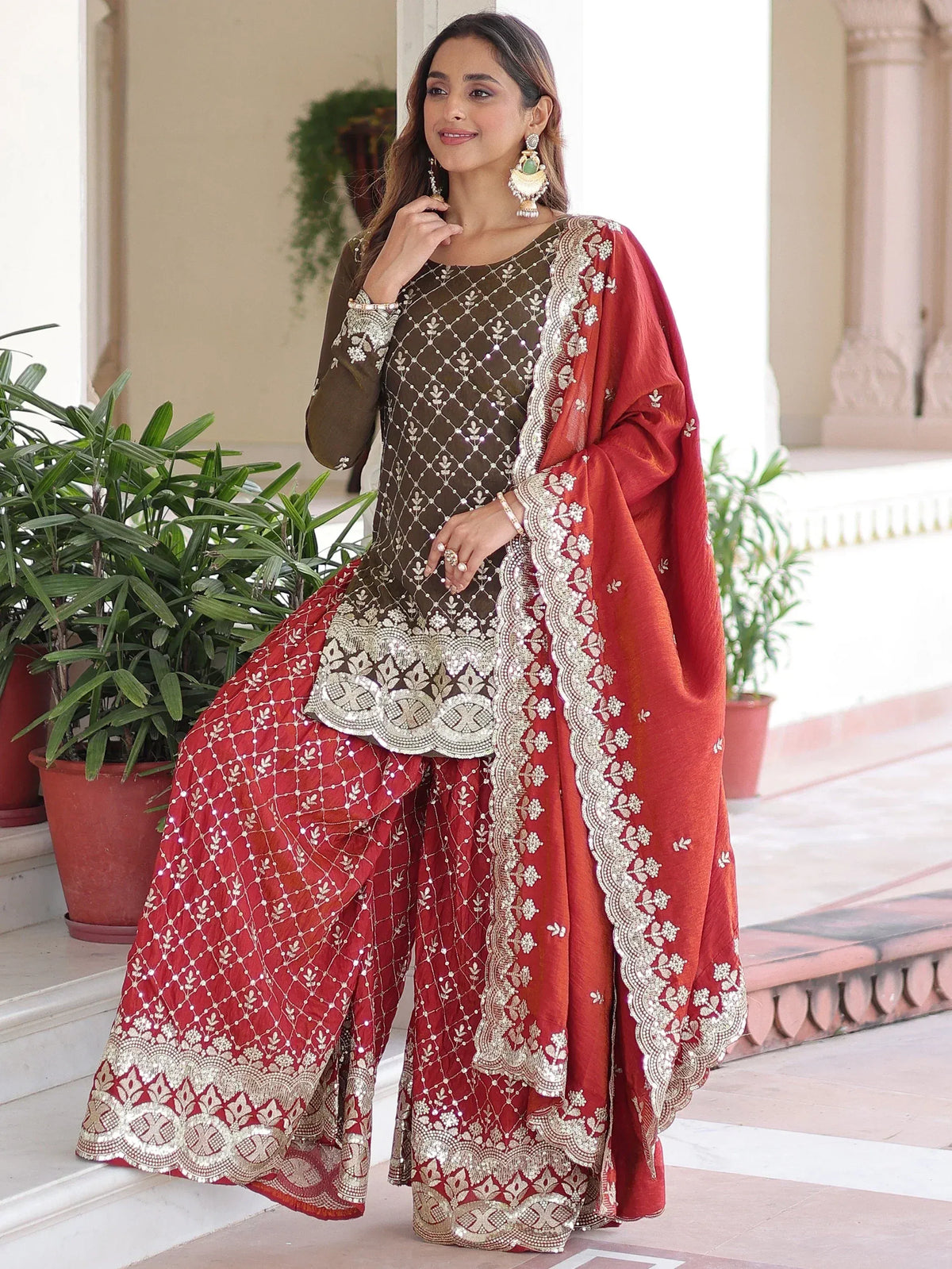 Elegant red and olive green embroidered sharara suit with intricate gold detailing, perfect for Indian ethnic occasions.