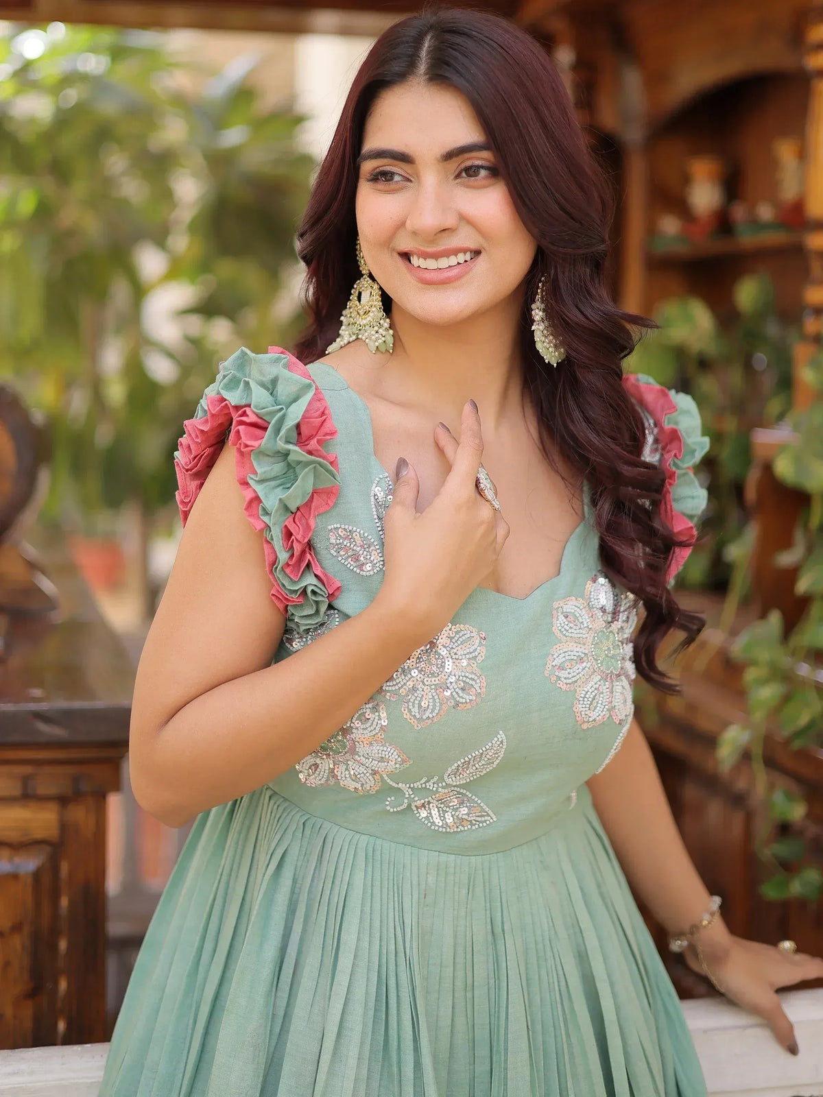 Mint green ethnic gown with floral sequin embroidery and ruffled sleeves, perfect for Indian occasions.
