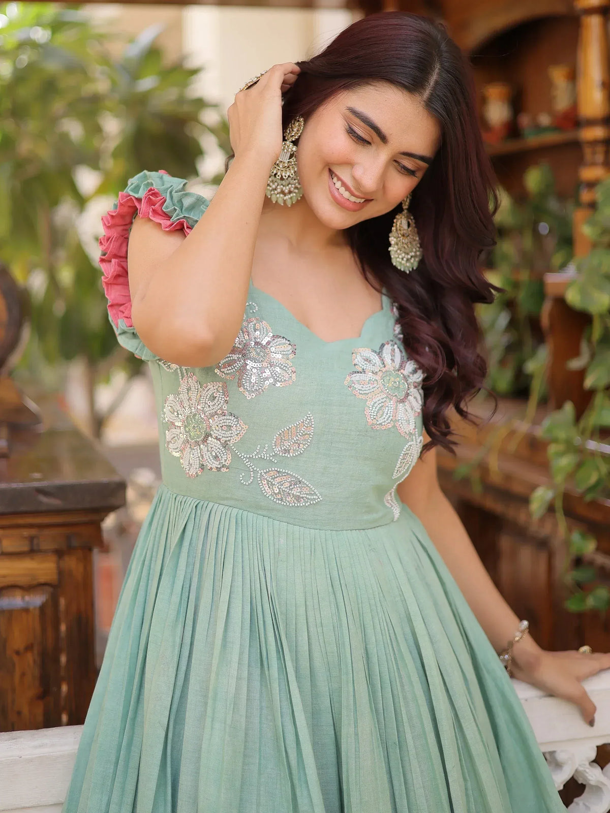 Mint green ethnic gown with floral embroidery and ruffled sleeves, perfect for Indian occasions