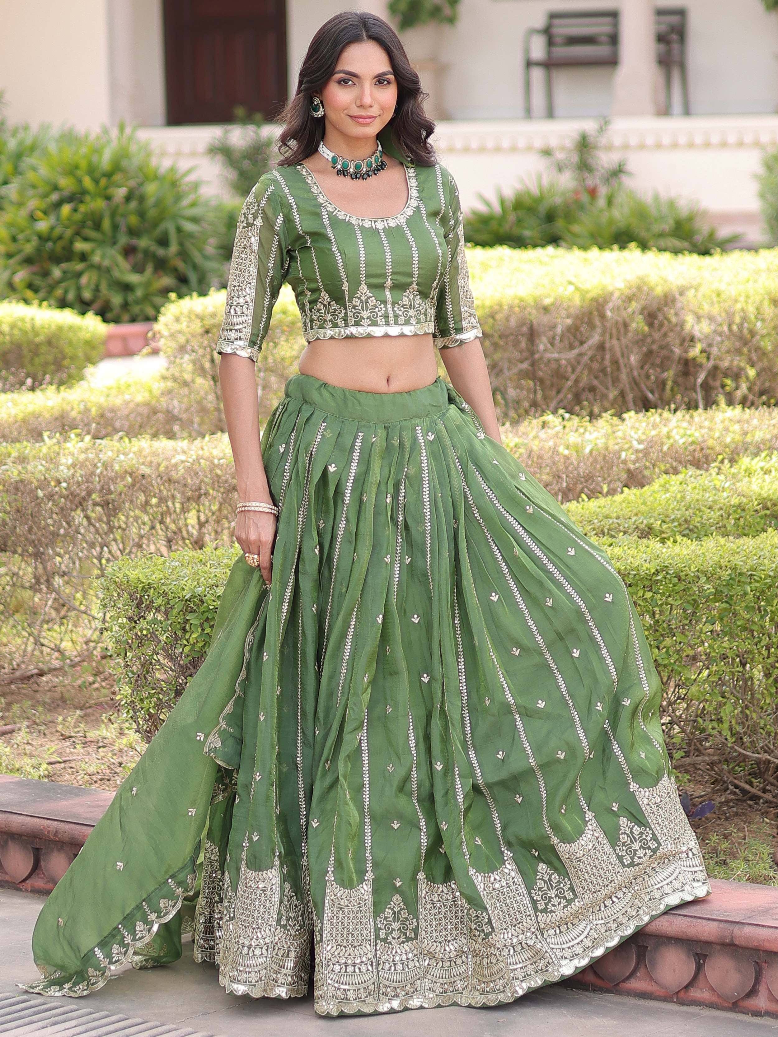 Green embroidered lehenga choli with silver detailing, perfect for Indian ethnic wear occasions.
