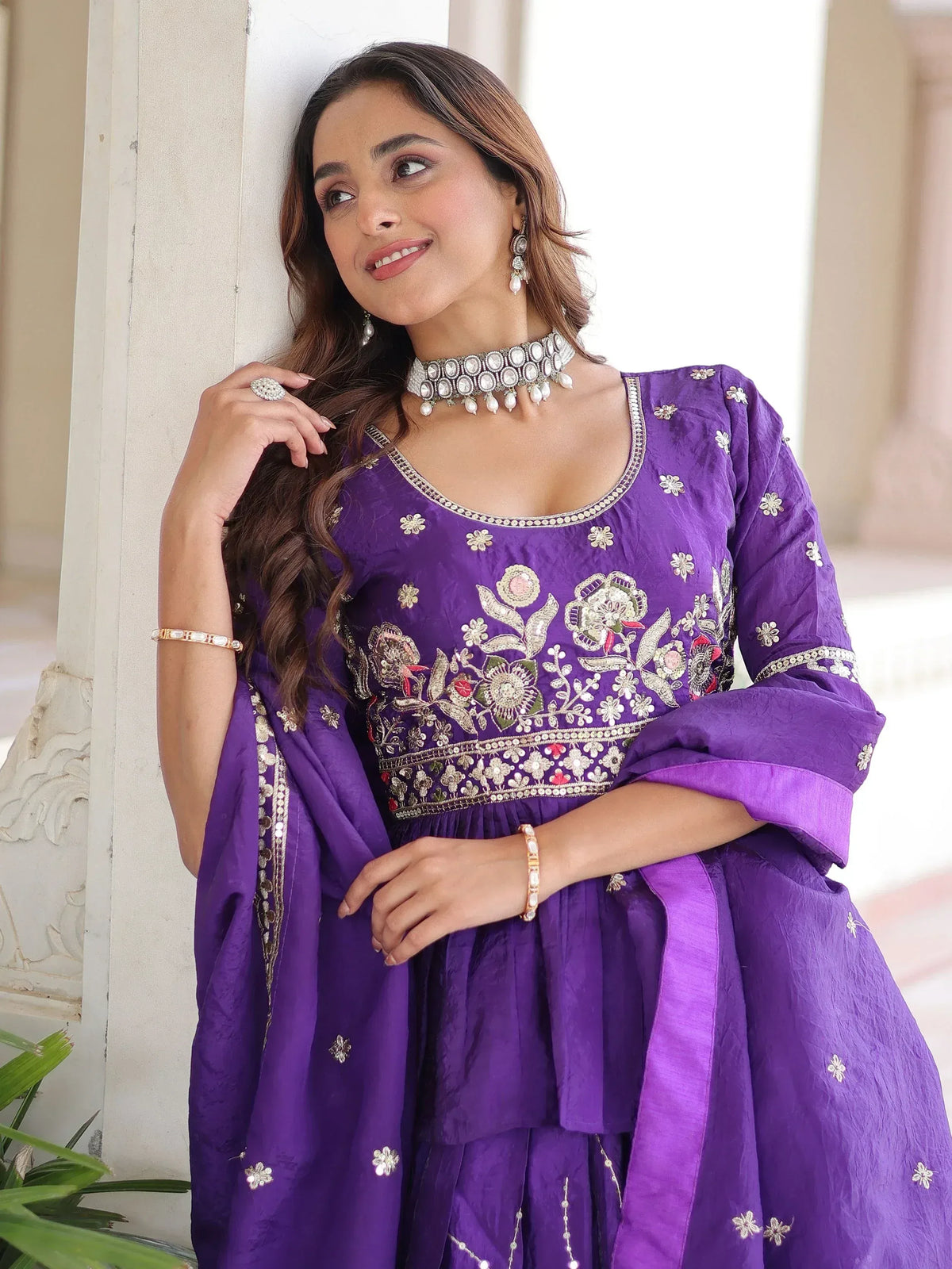 Purple embroidered ethnic gown with floral motifs, perfect for Indian occasions and festive wear