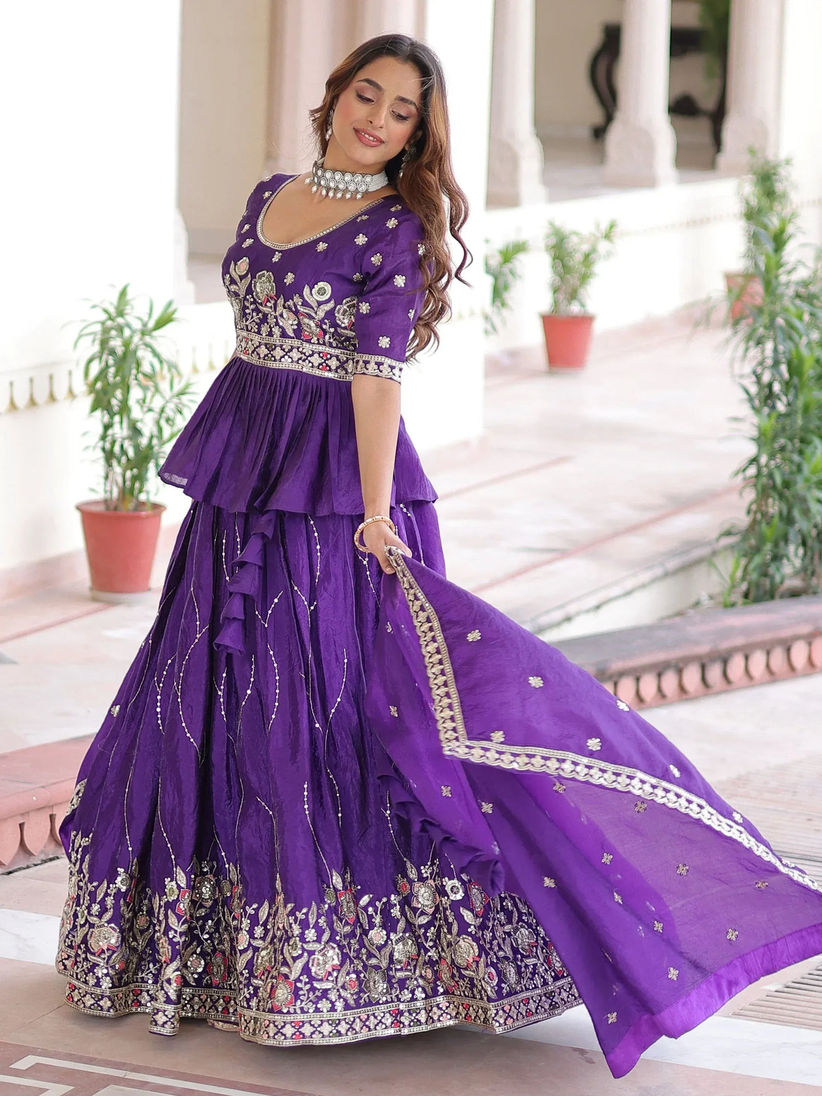 Purple embroidered lehenga choli with floral motifs and ruffled skirt, perfect for Indian ethnic wear occasions.