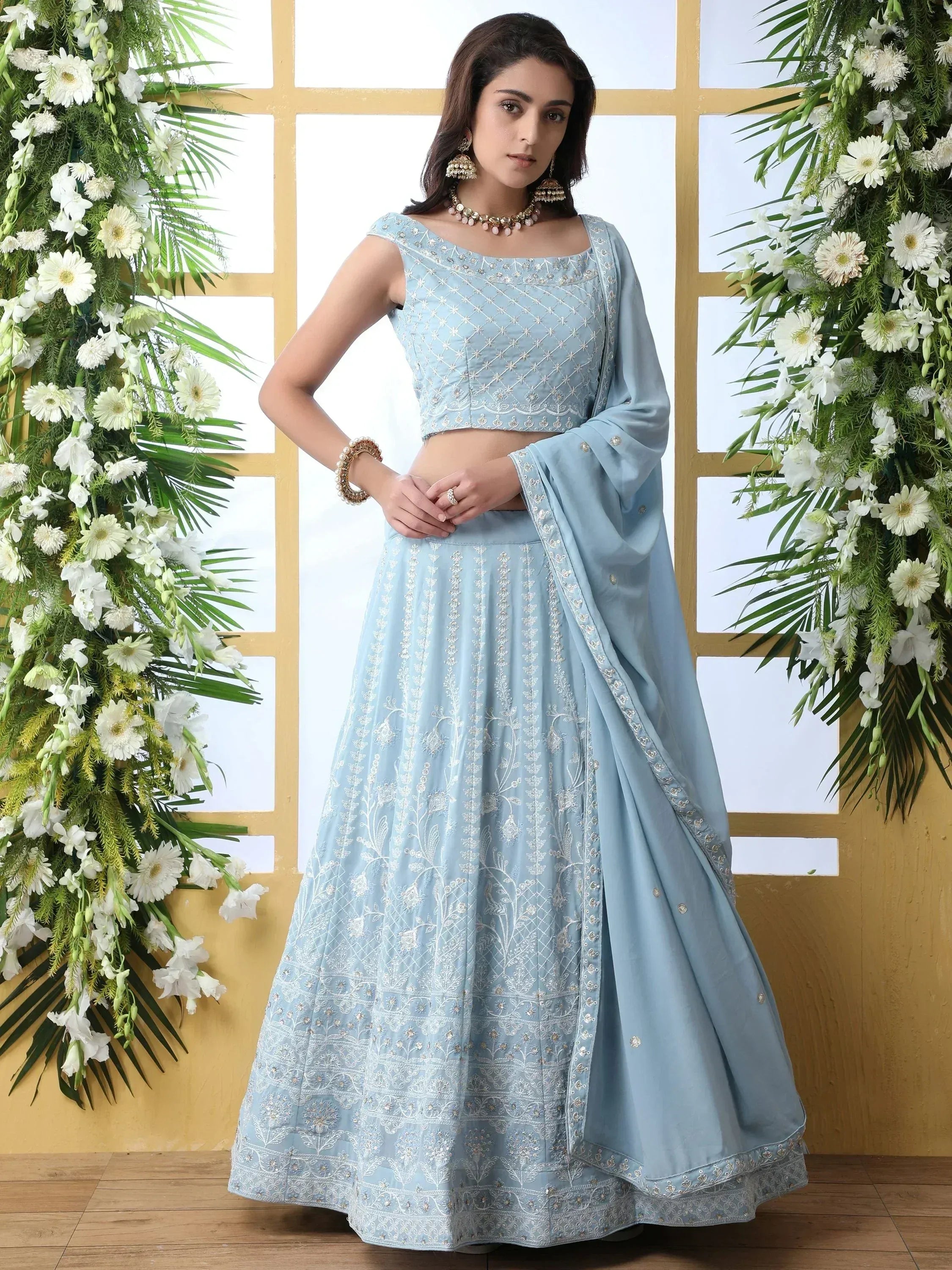 Light blue embroidered lehenga choli with floral motifs, perfect for Indian ethnic wear events