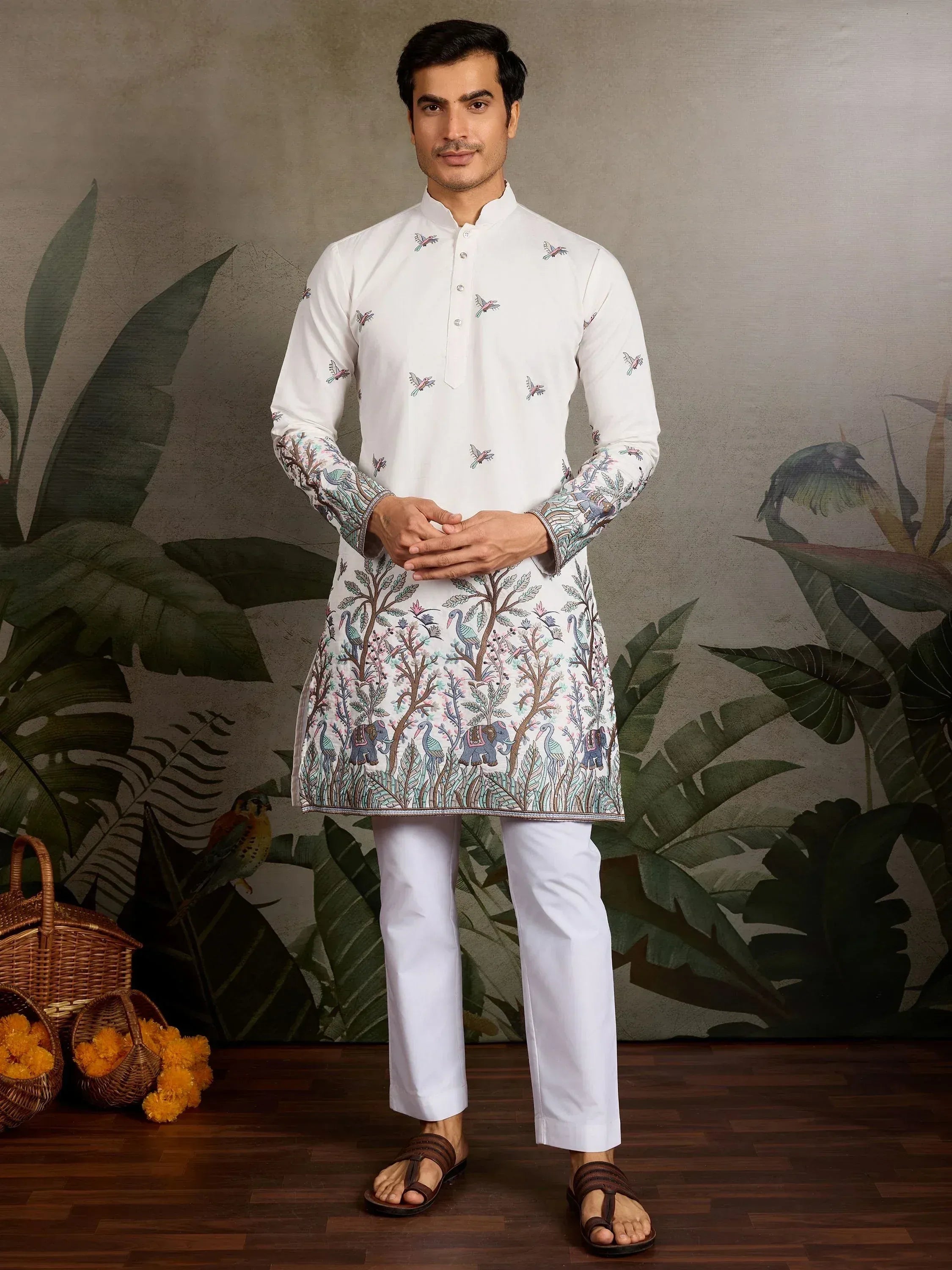 White embroidered kurta with bird and elephant print, paired with churidar pants for men's ethnic wear