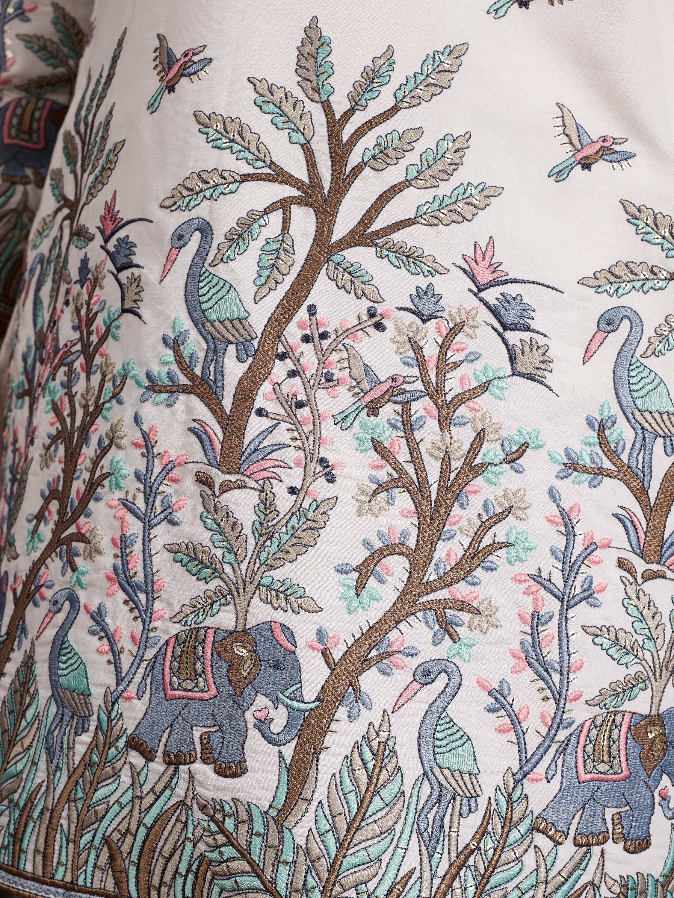 Embroidered ethnic wear with elephants, birds, and trees in pastel tones for Indian festive occasions.
