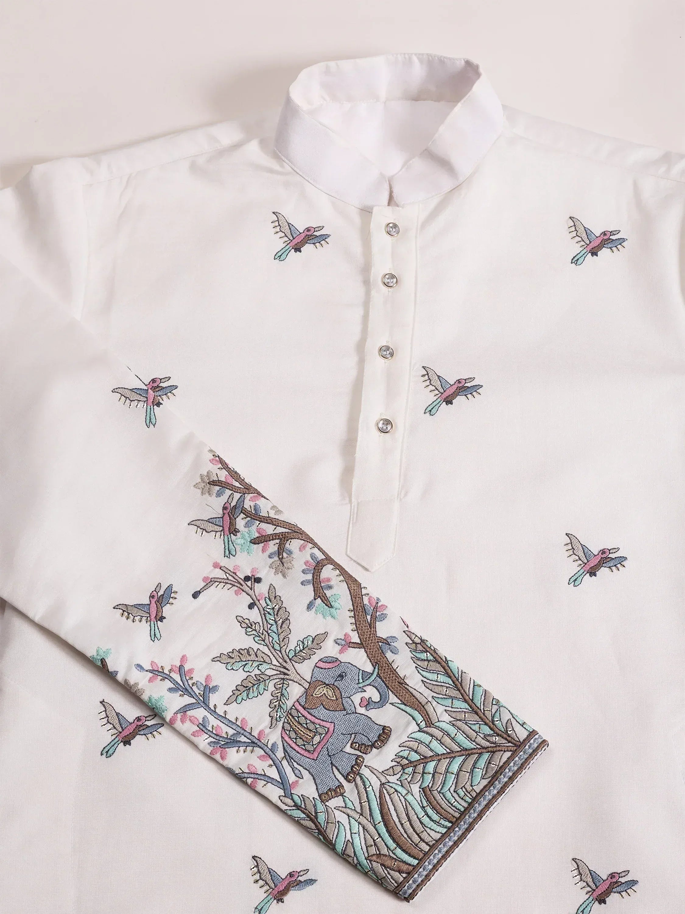 White ethnic kurta with colorful bird and elephant embroidery, perfect for Indian festive wear.