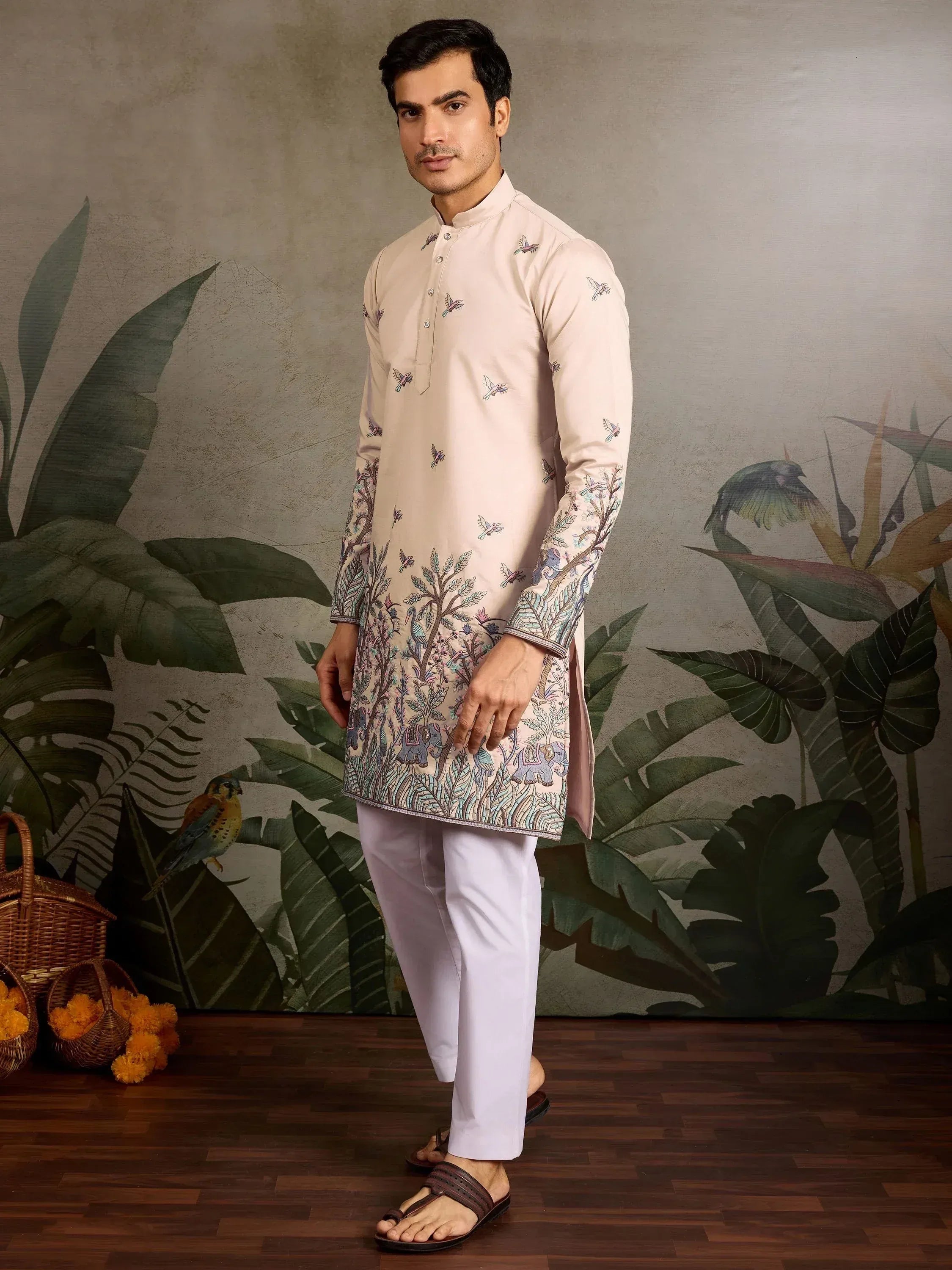 Men's ethnic kurta with bird and elephant print, paired with white pants for festive occasions