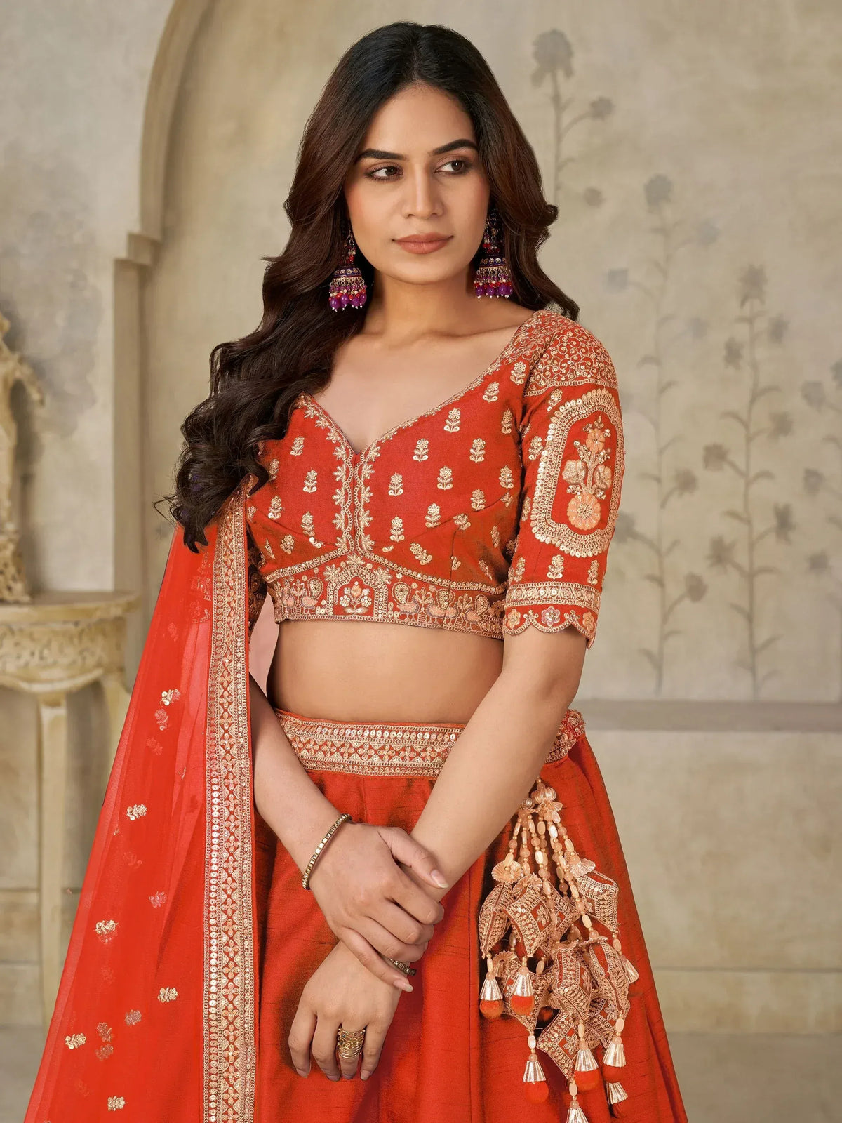 Orange embroidered lehenga choli with gold detailing, perfect for Indian ethnic wear and festive occasions.