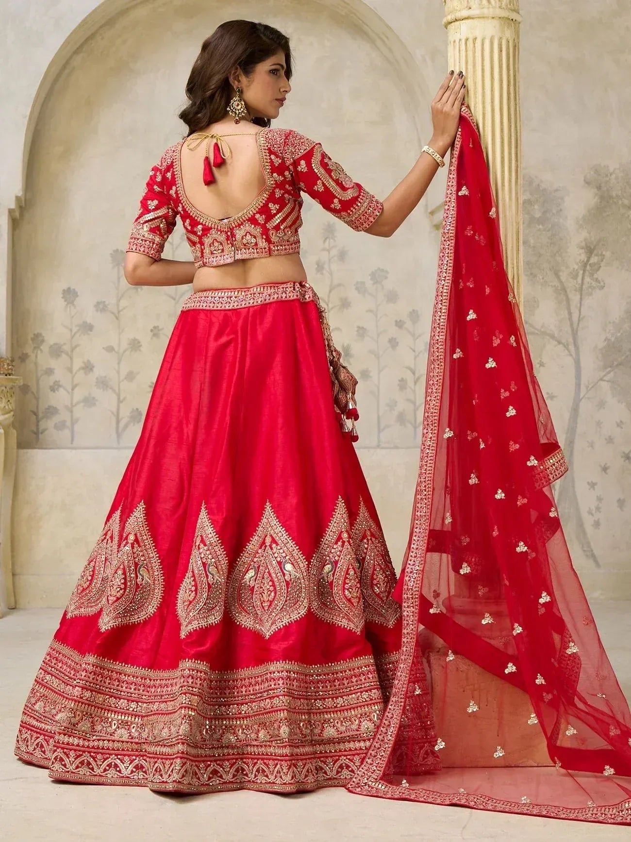 Red designer lehenga choli with gold embroidery, backless blouse, and matching dupatta for Indian ethnic wear