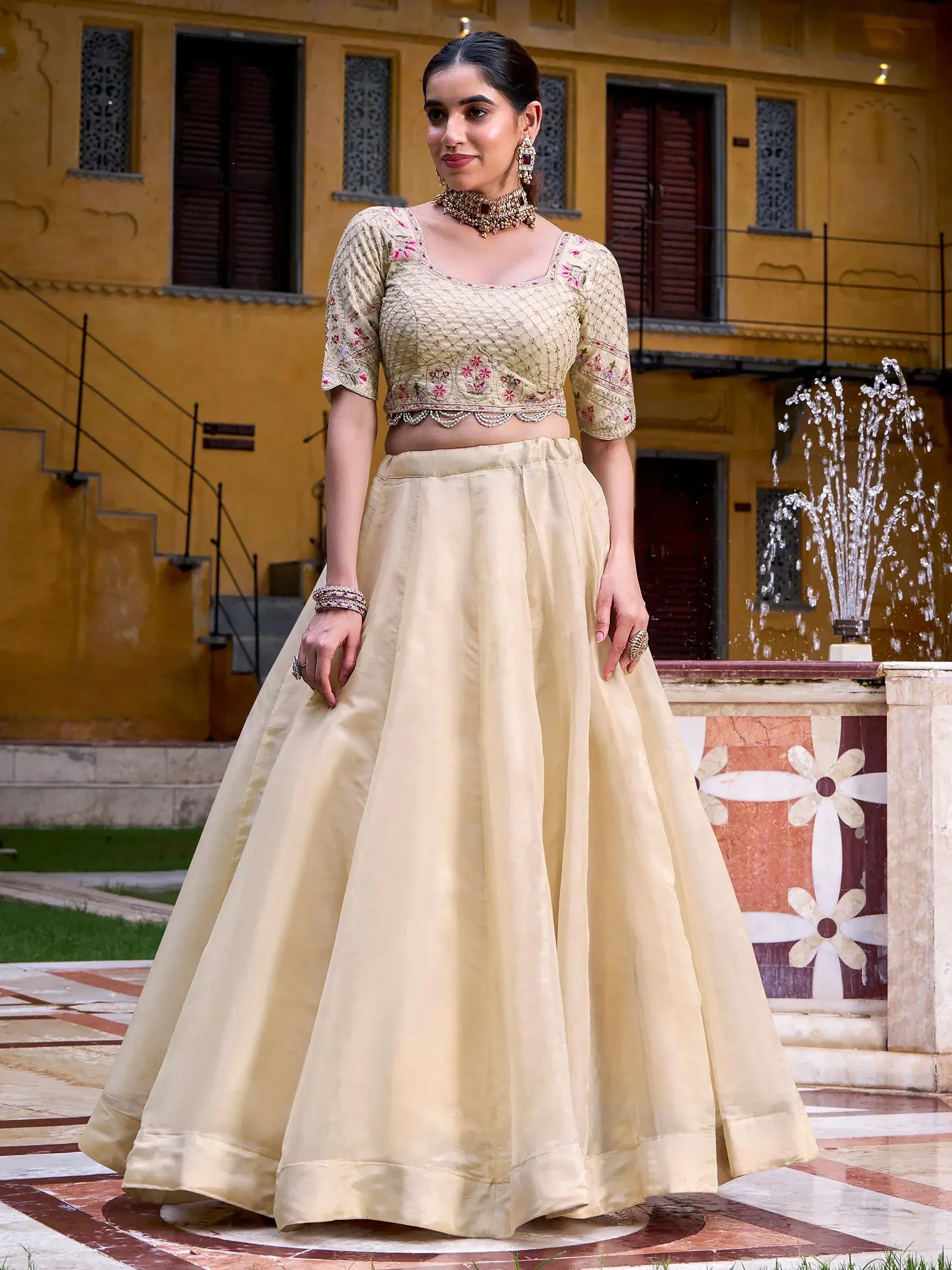 Elegant beige lehenga choli with floral embroidery, perfect for Indian ethnic occasions and weddings.