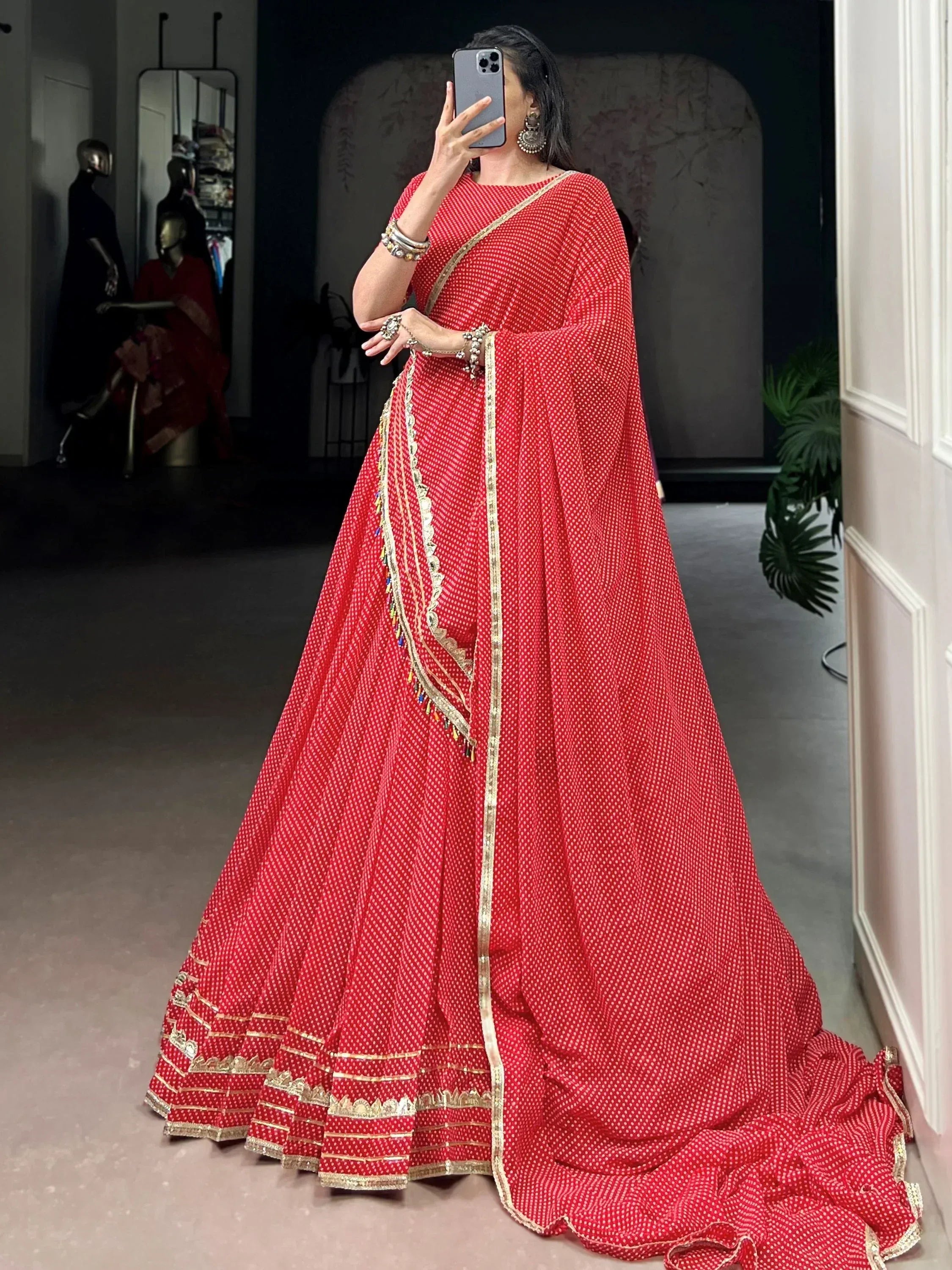 Red ethnic lehenga choli with gold embroidery and polka dots, perfect for Indian weddings and festivals