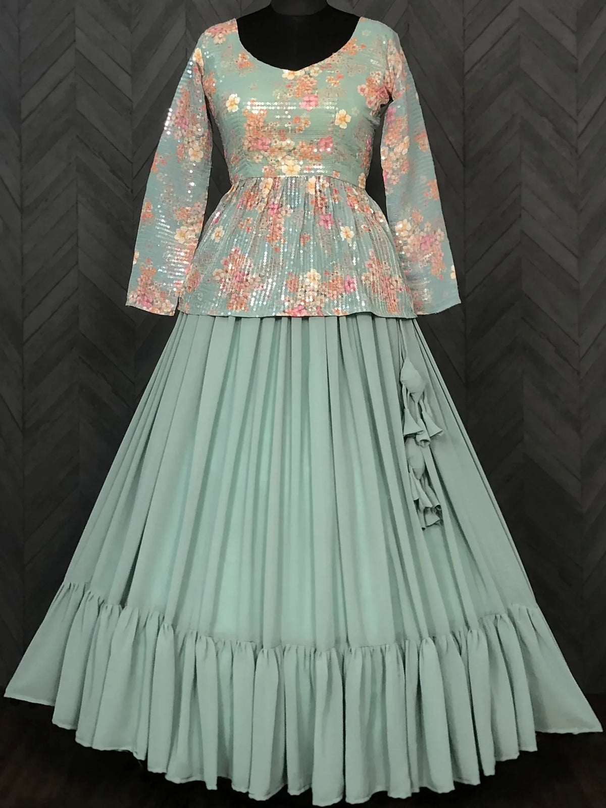 Mint green ethnic gown with a floral sequined bodice and a pleated flowing skirt.