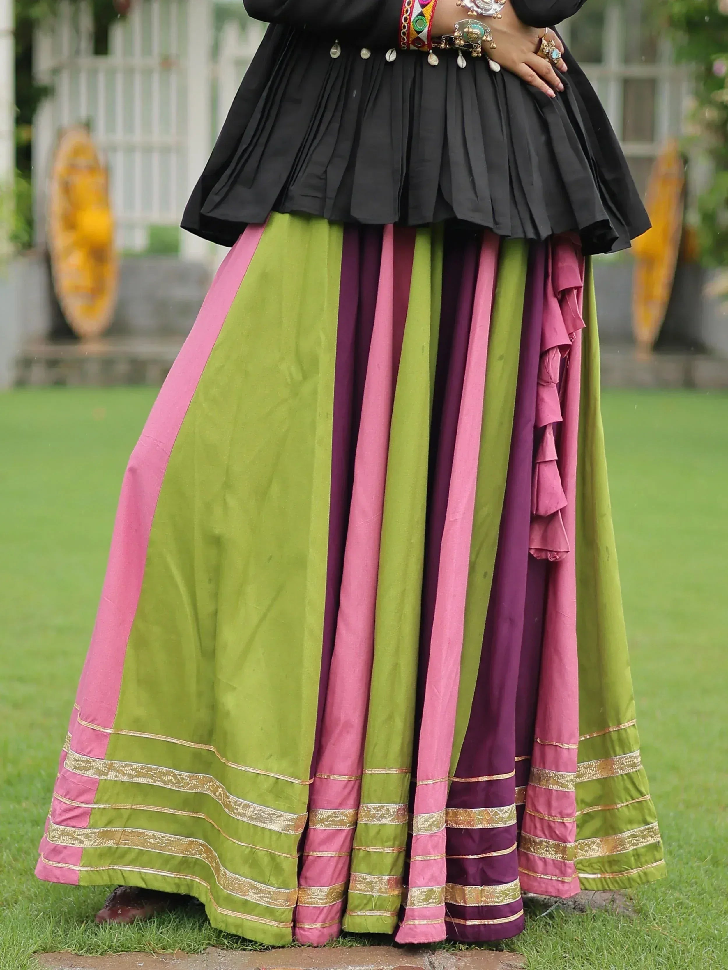 Black pleated top with colorful striped ethnic skirt, perfect for Indian festive wear