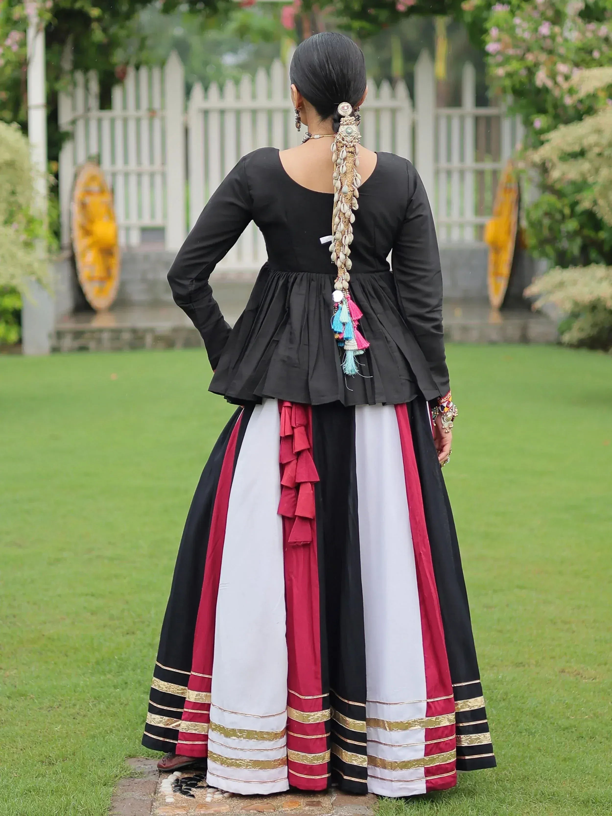 Black peplum top with color-blocked skirt, shell hair accessory, ethnic Indian wear