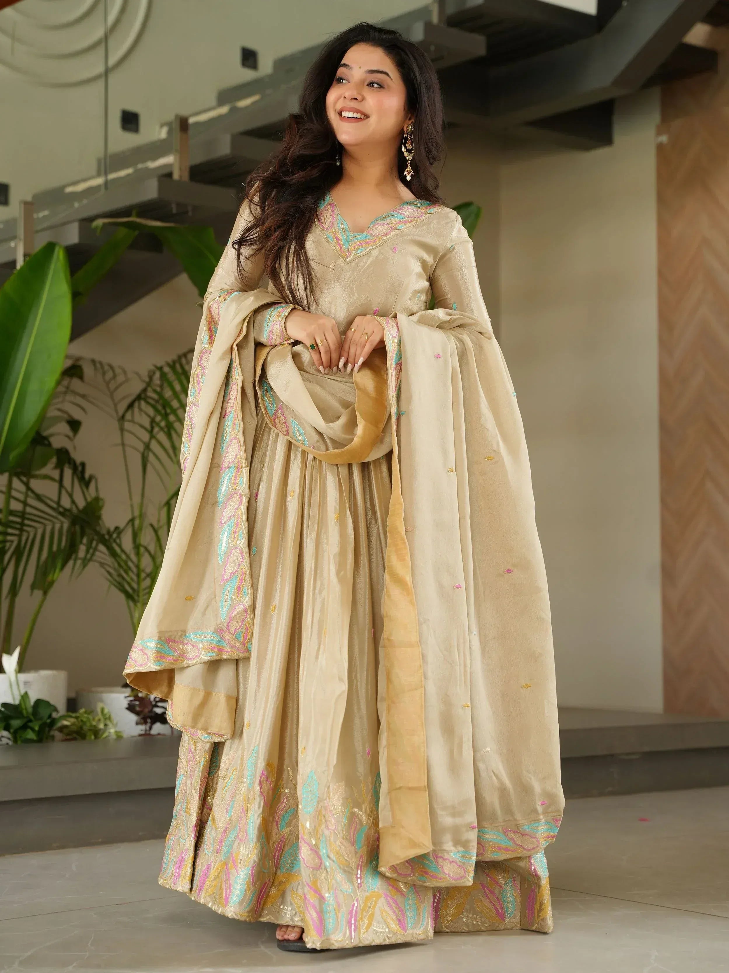 Beige embroidered sharara suit with pastel floral motifs, perfect for Indian ethnic wear occasions