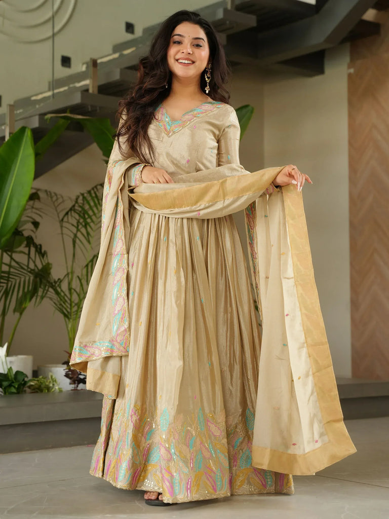 Elegant beige embroidered anarkali suit with colorful floral motifs and dupatta, perfect for Indian ethnic occasions