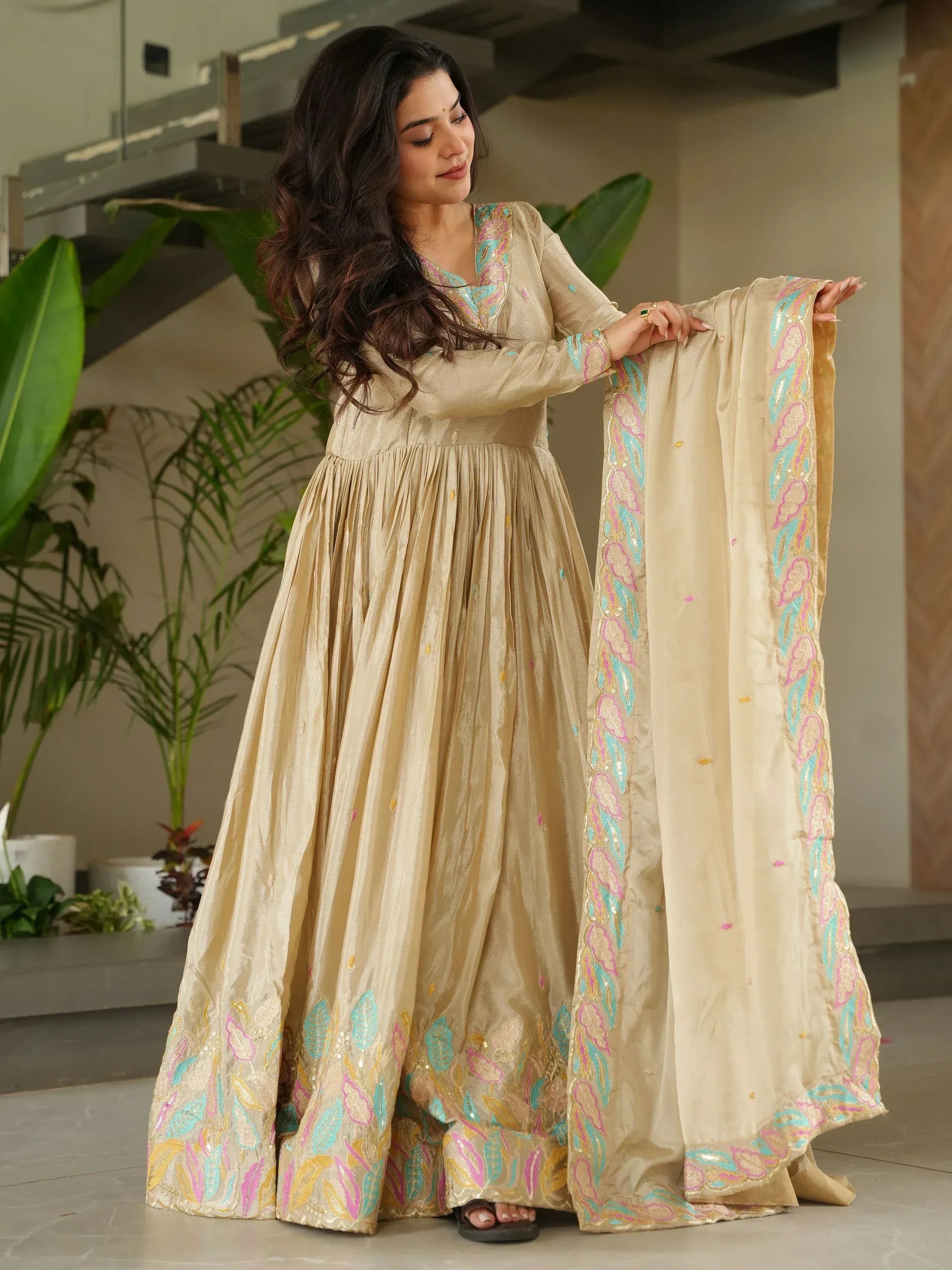 Beige embroidered anarkali suit with colorful floral detailing, perfect for Indian ethnic wear occasions.