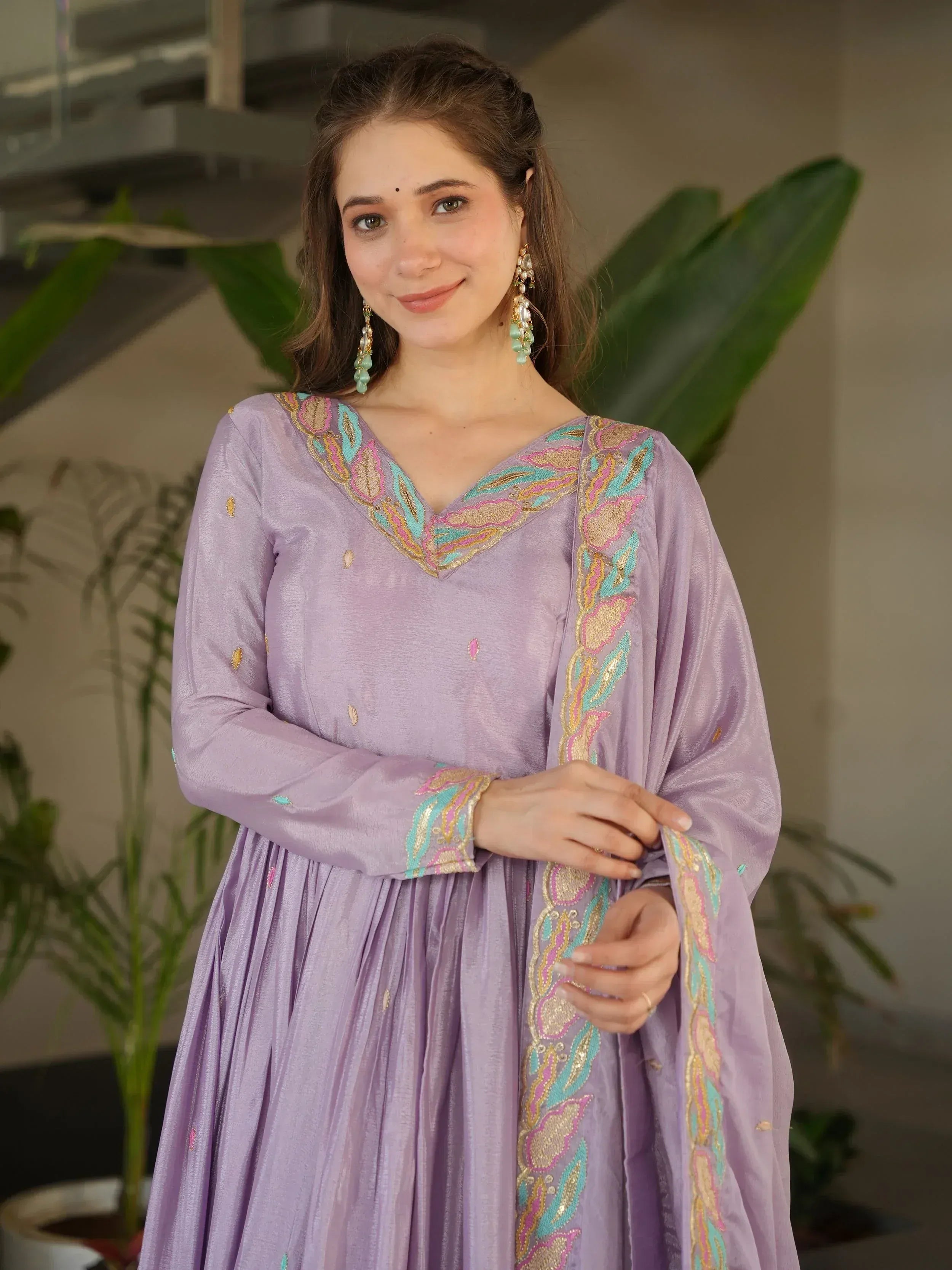 Lavender ethnic gown with colorful embroidery, perfect for Indian occasions and festive wear.