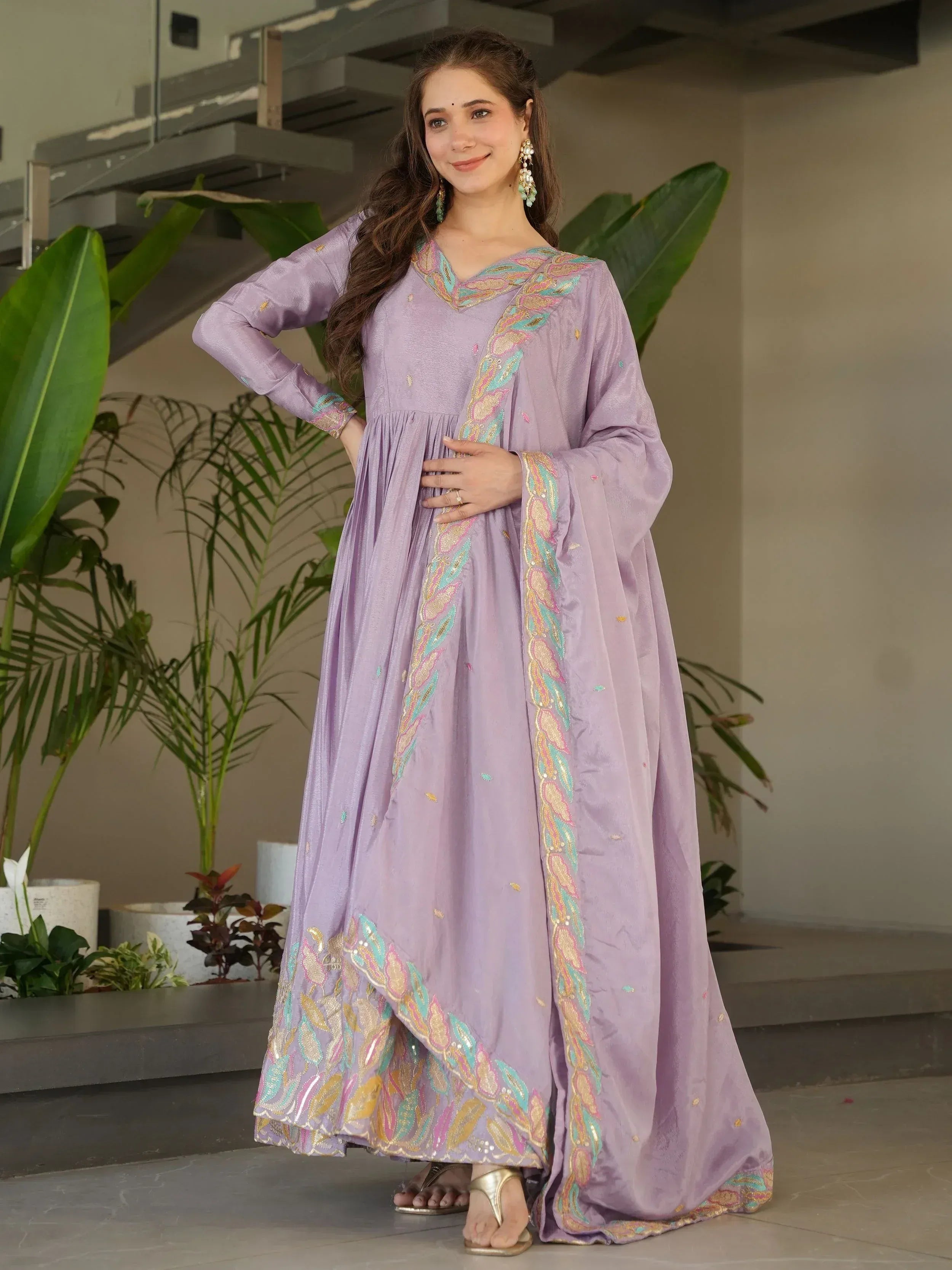 Lavender ethnic gown with colorful embroidery, perfect for Indian occasions and festive wear.